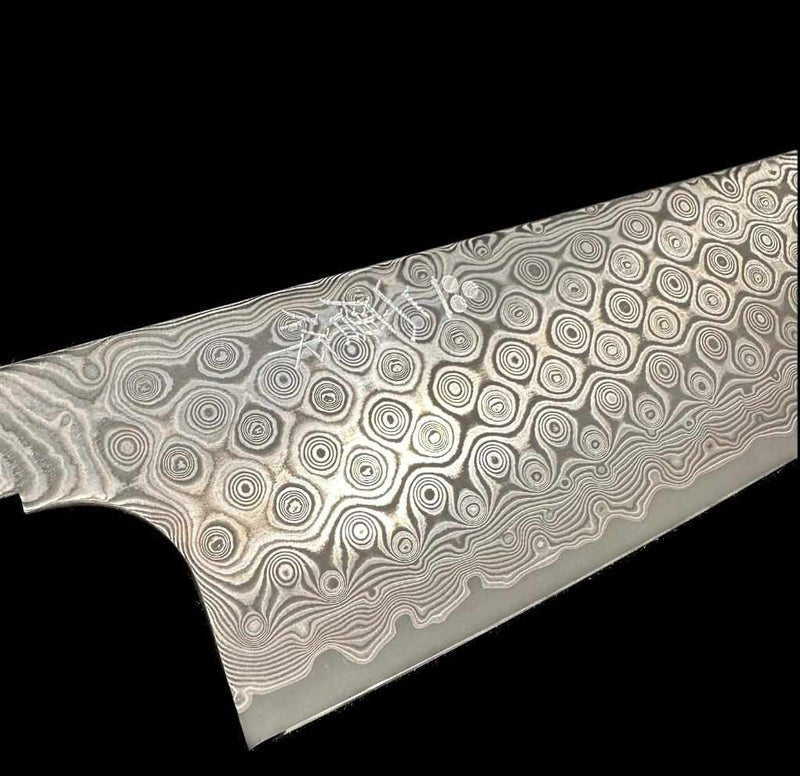 Nigara Hamono's 240mm SG2 Anmon Gyuto on a black background