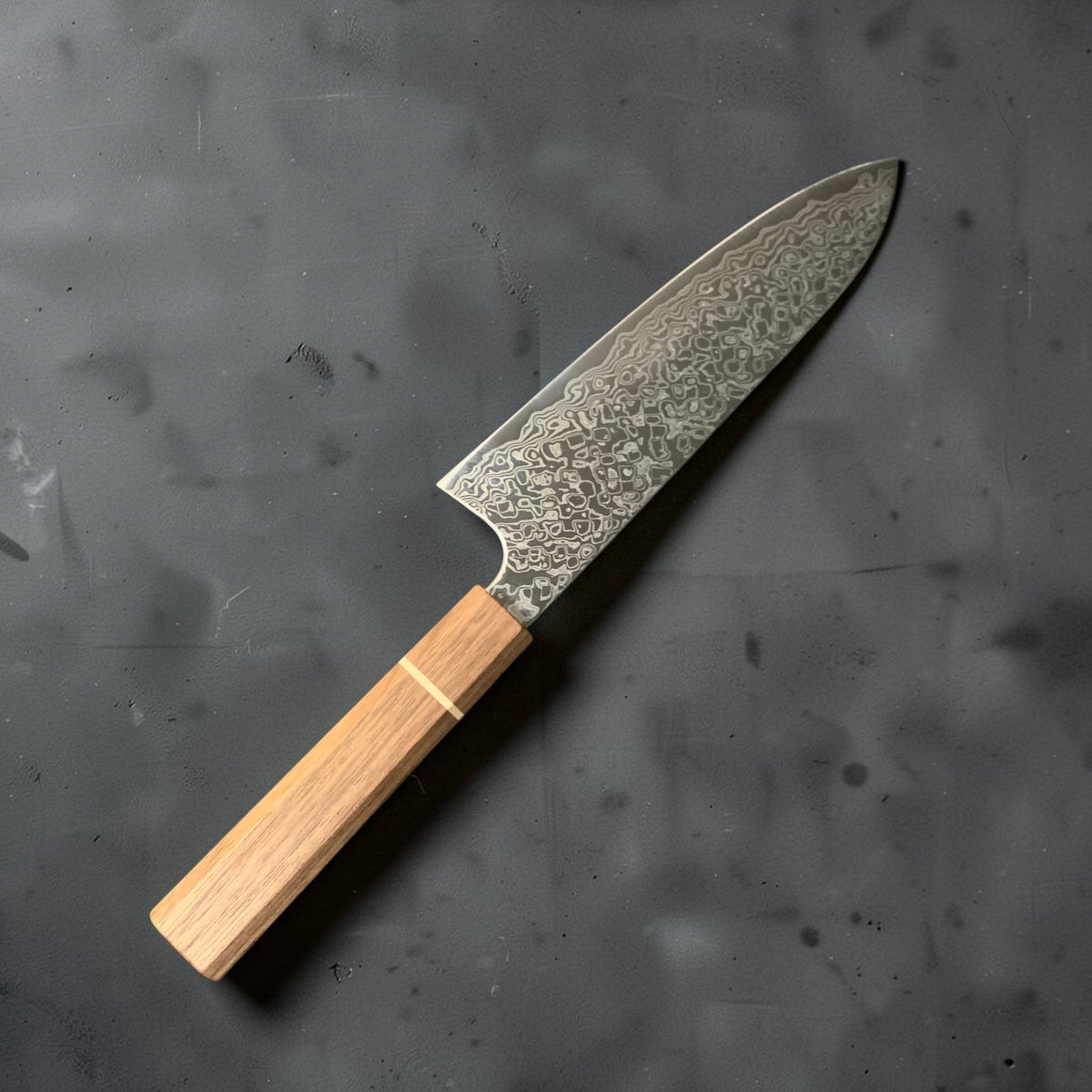 Reverse side of the Hatsukokoro Ginga 180mm santoku showing Damascus cladding and Sanjo handle