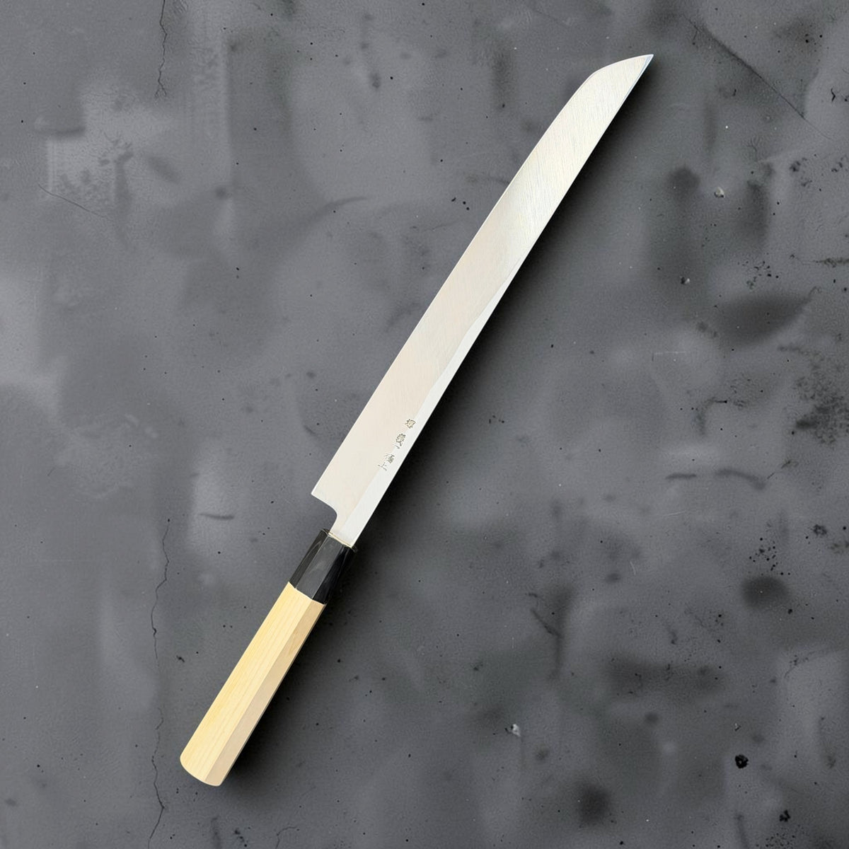 Reverse side of Yoshikazu Tanaka 300mm sakimaru yanagiba showing the hollow-ground back