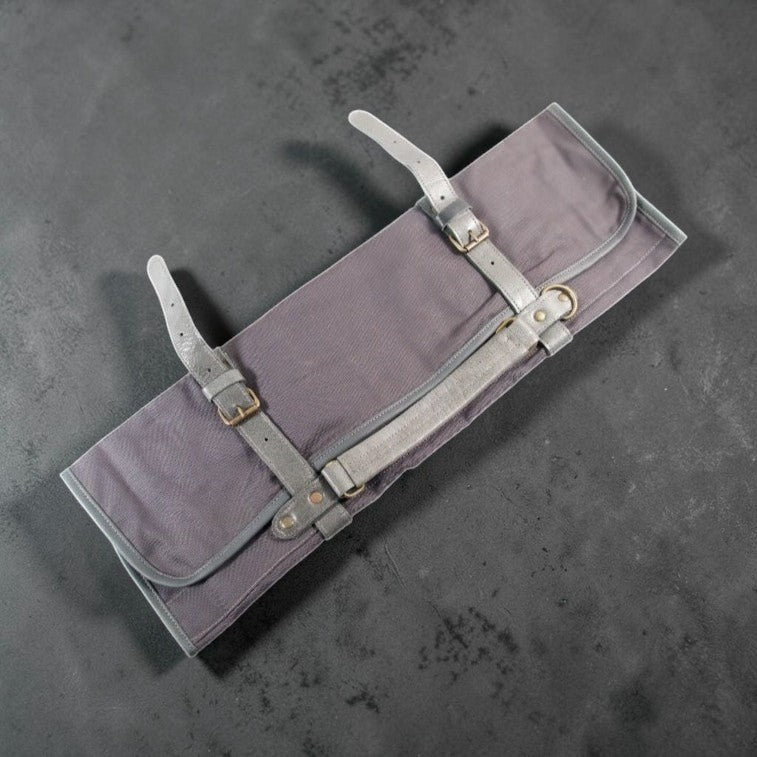 Blue canvas knife roll with grey leather straps