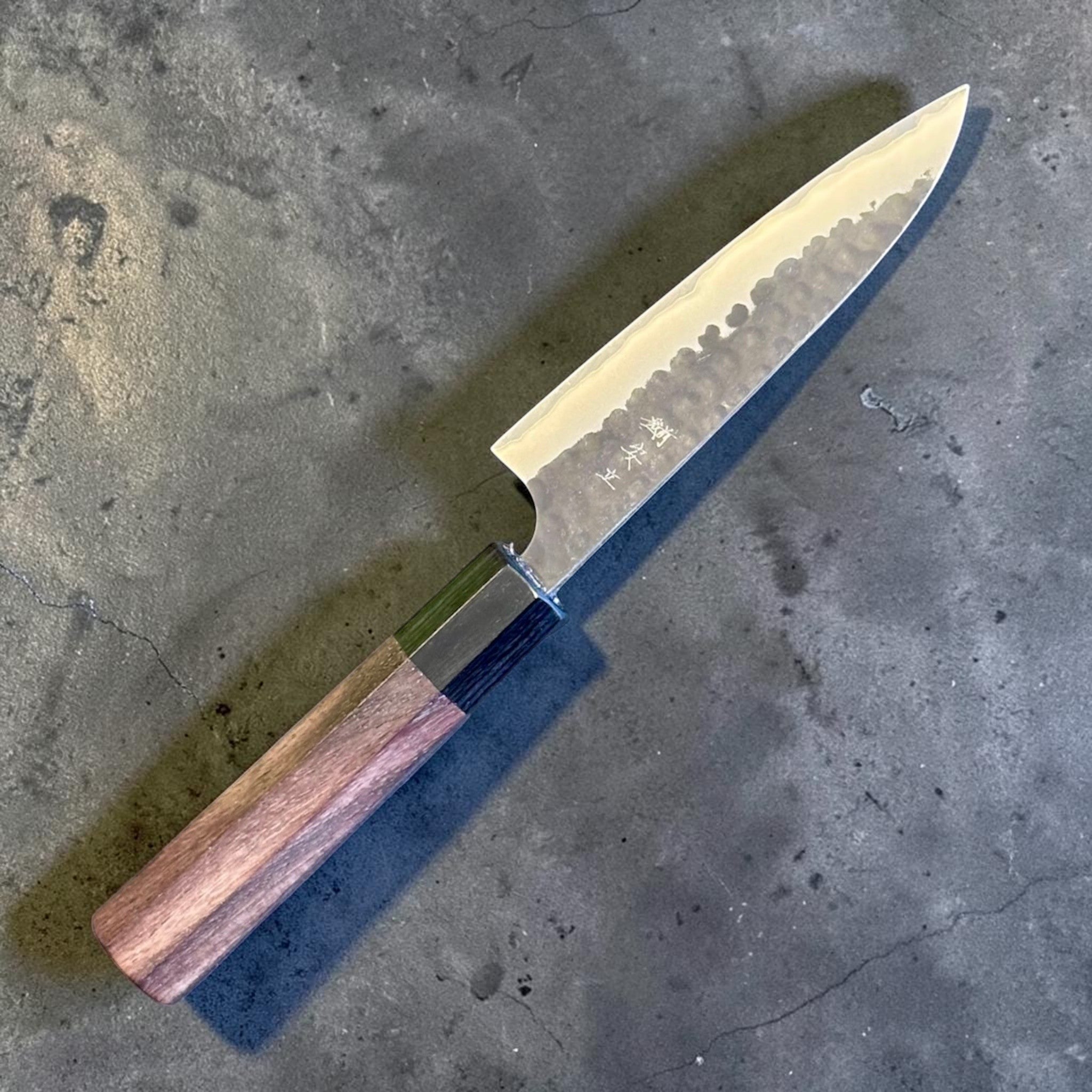 Anryu Aogami Super Kuro Tsuchime Petty 120 mm with rosewood octagon handle, opposite angled view showing the slim pointed tip and handcrafted handle geometry.