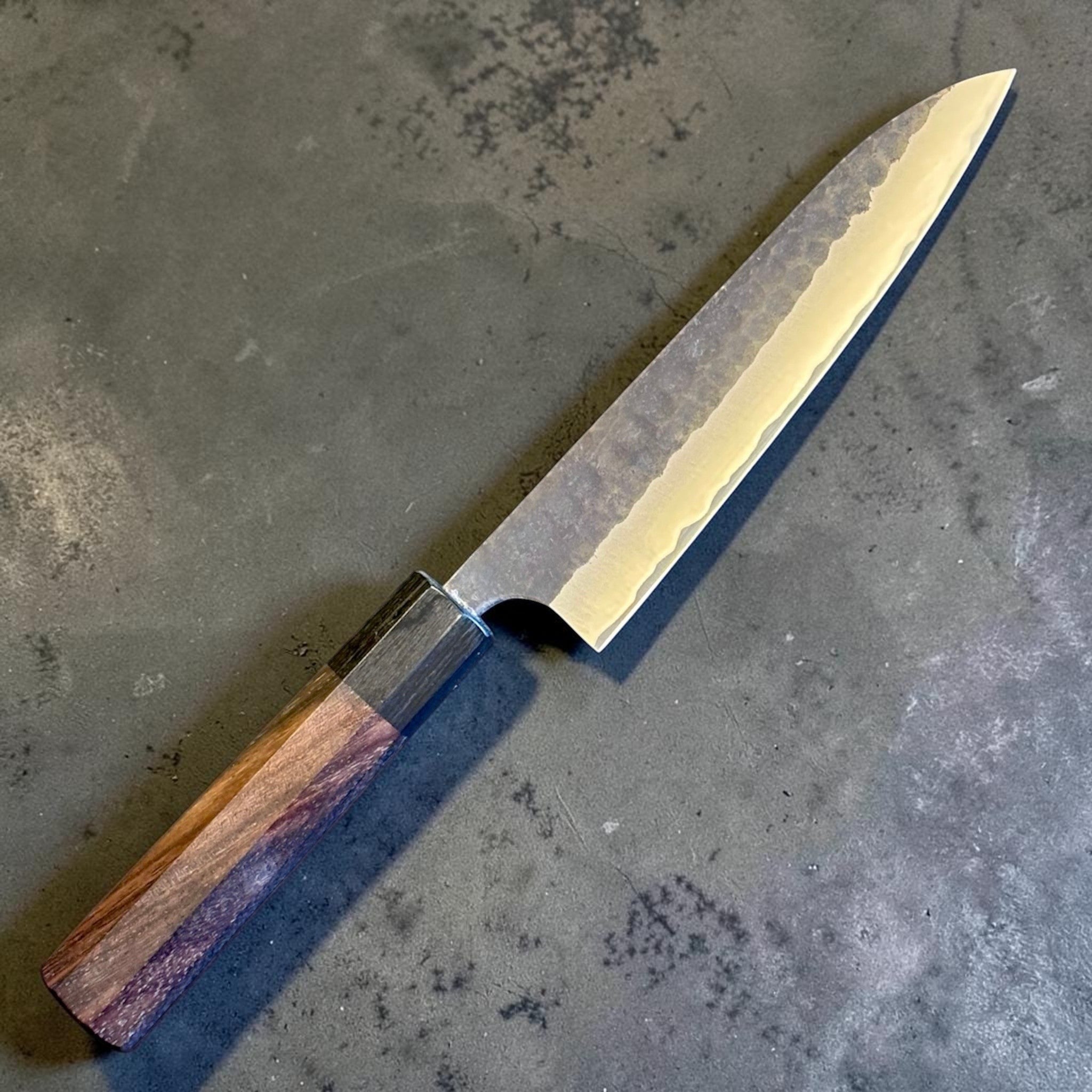 Anryu Aogami Super Kuro Tsuchime Petty 150 mm with rosewood octagon handle, angled view highlighting the slim pointed tip and gentle taper.