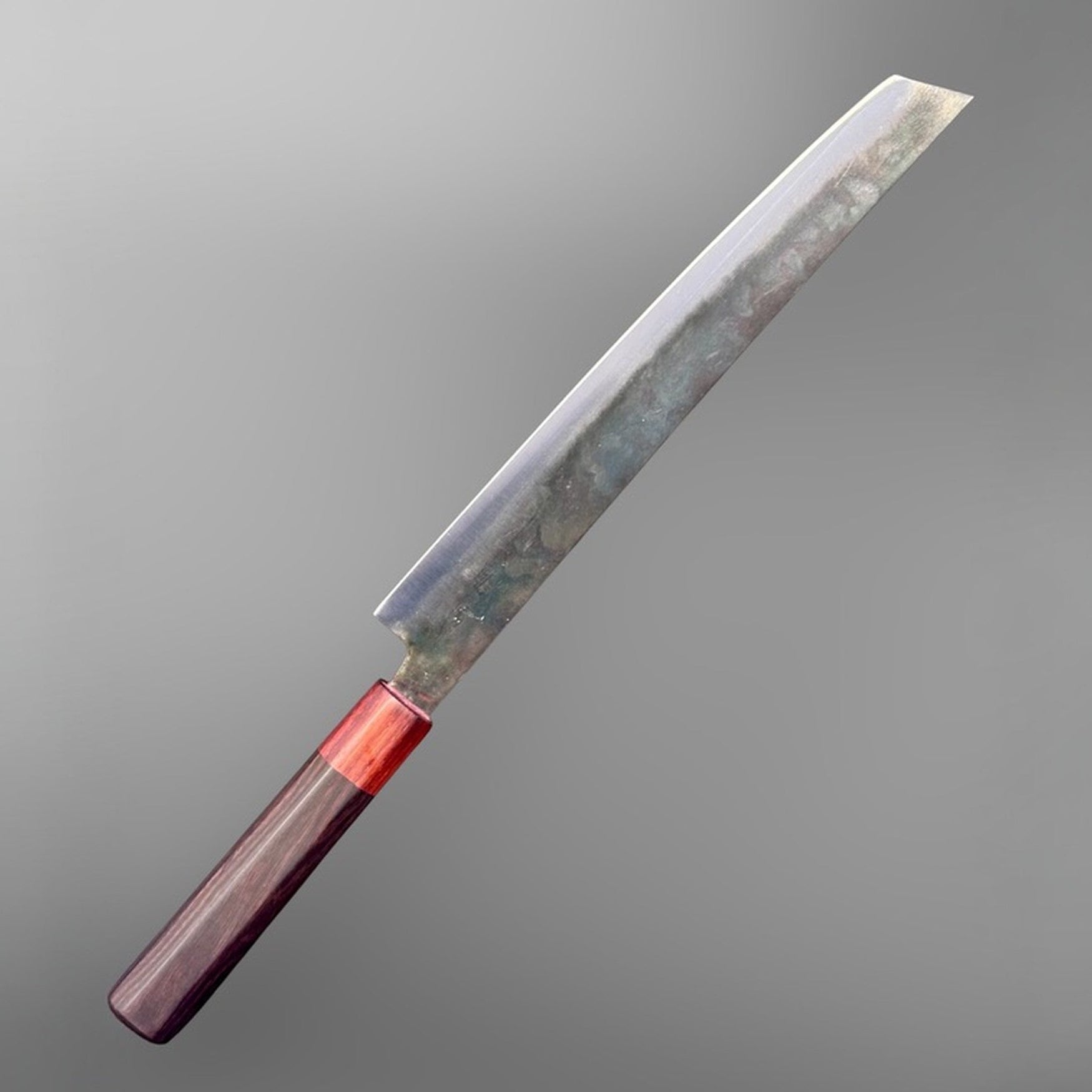 Dao Vua V3 52100 carbon steel 270 mm sakimaru sujihiki slicer, angled left-side product view with dark wa handle and red ferrule.