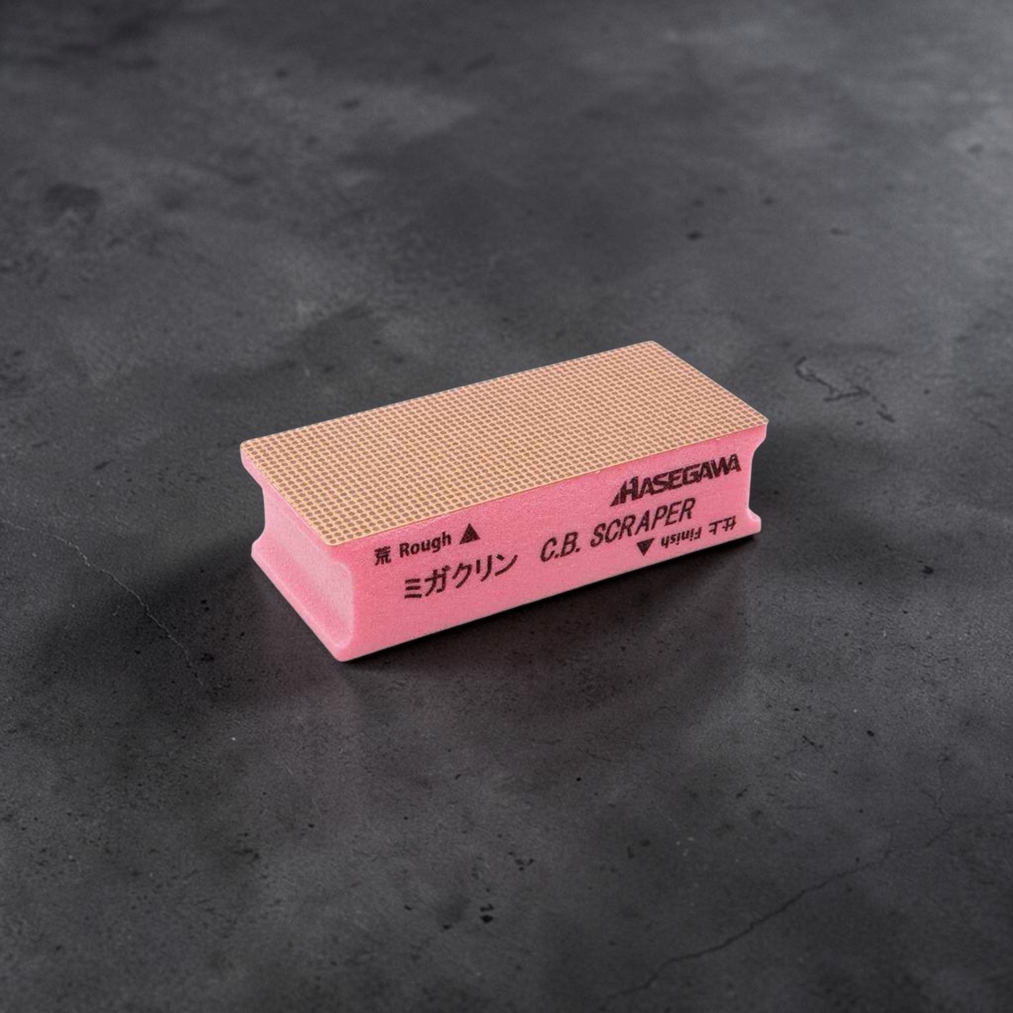 Hasegawa Cutting Board Scraper, pink scraper block with textured rough surface for cleaning and resurfacing cutting boards.