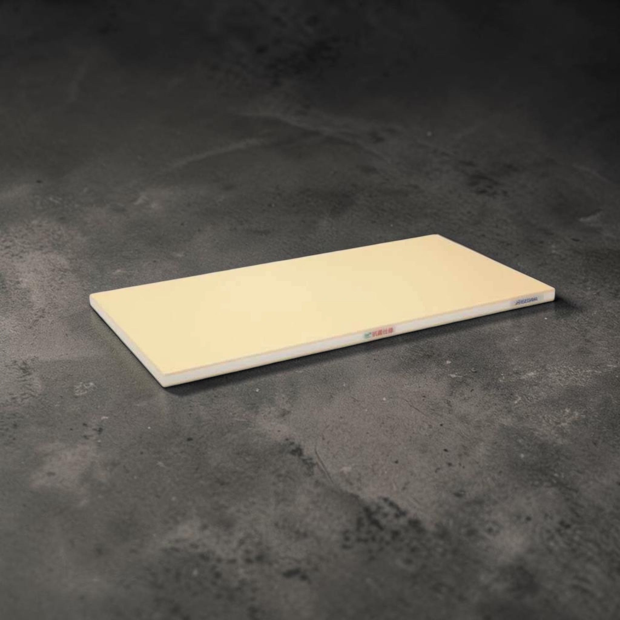 Hasegawa FSR cutting board, cream colored synthetic board shown on a dark textured surface.