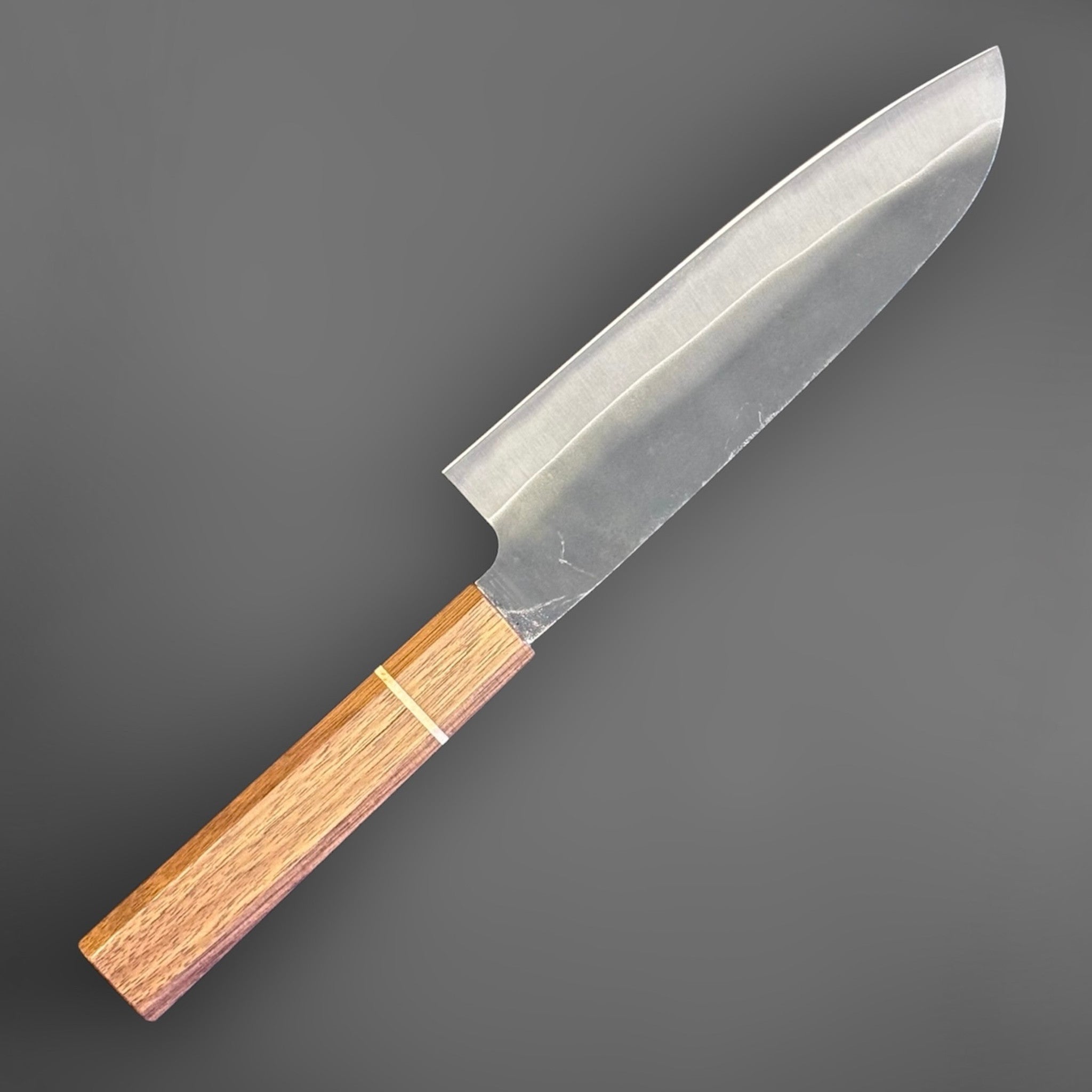 Hatsukokoro Aokitae Blue #2 Kurouchi Santoku 180 mm with Sanjo walnut handle and maple stripe, angled back side view showing the grind and blade profile.