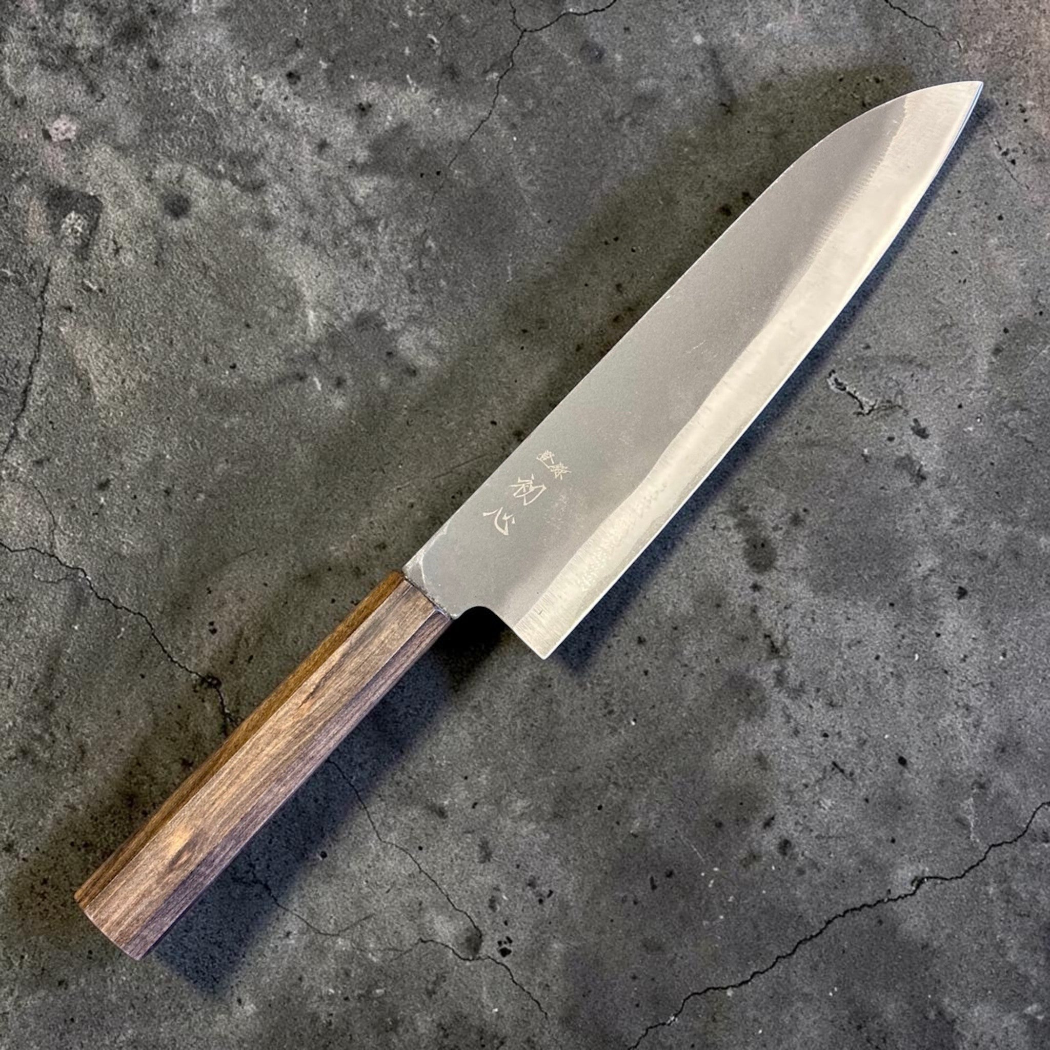 Hatsukokoro Blue #2 Kurouchi Gyuto 220 mm with mono ebony handle, angled full view of the blade and handle.