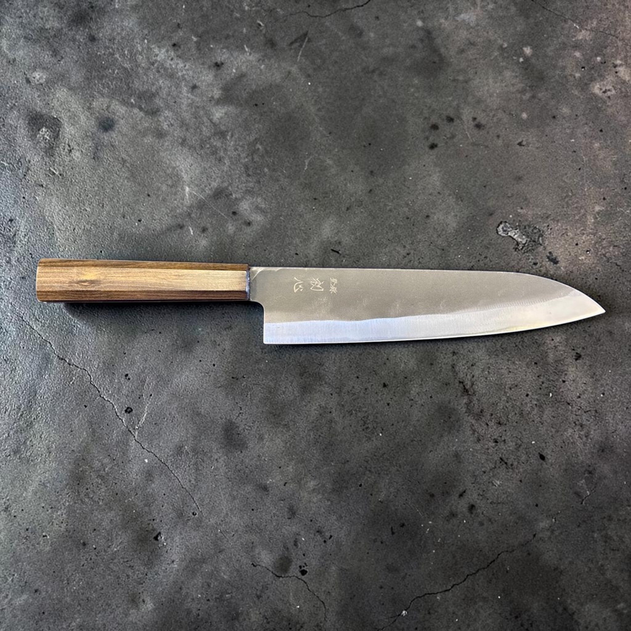 Hatsukokoro Blue #2 Kurouchi Gyuto 220 mm with mono ebony handle, full side profile showing the gentle gyuto curve.