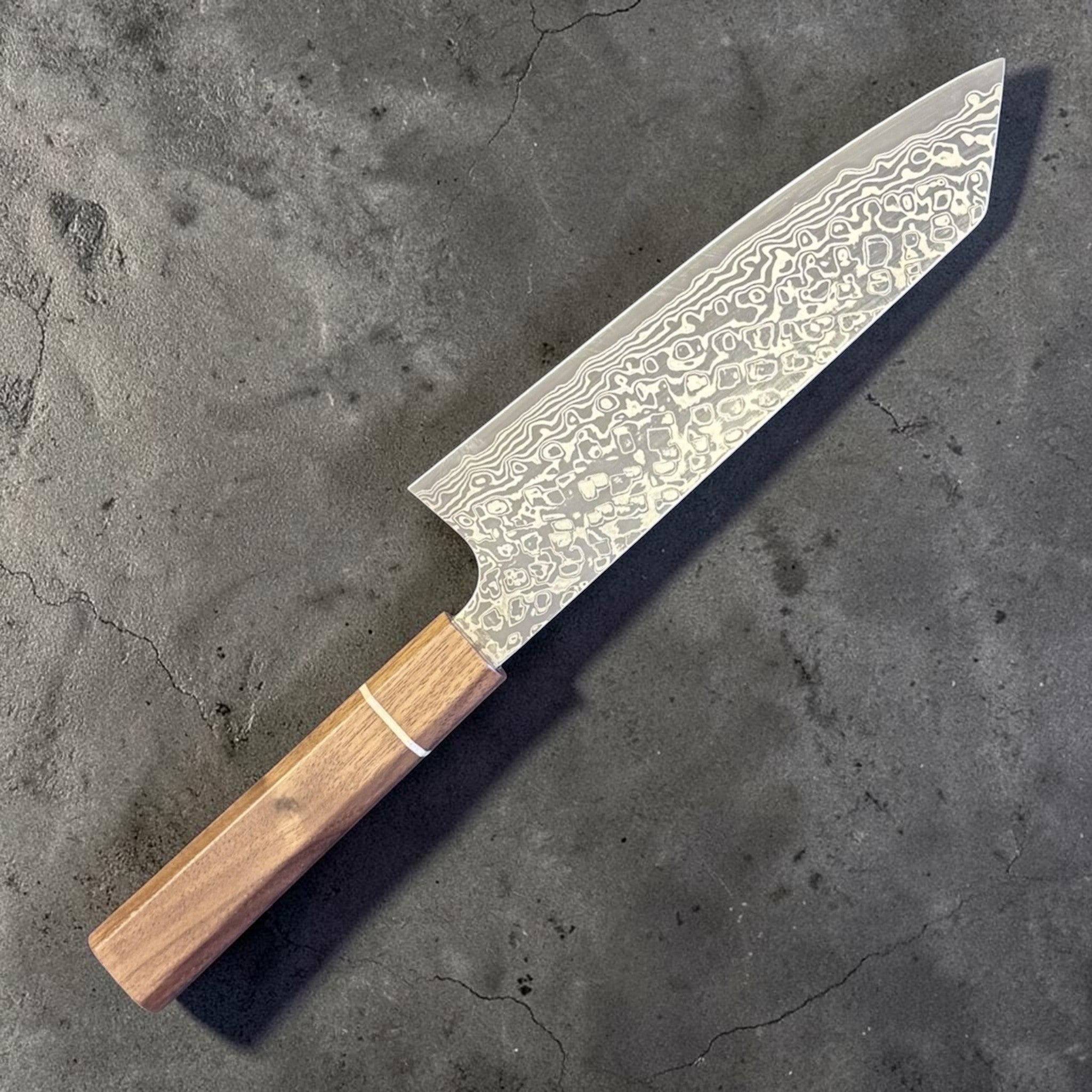 Hatsukokoro Ginga ATS-34 Nickel Damascus Bunka 170 mm with Sanjo walnut handle and maple stripe, angled reverse-side view.