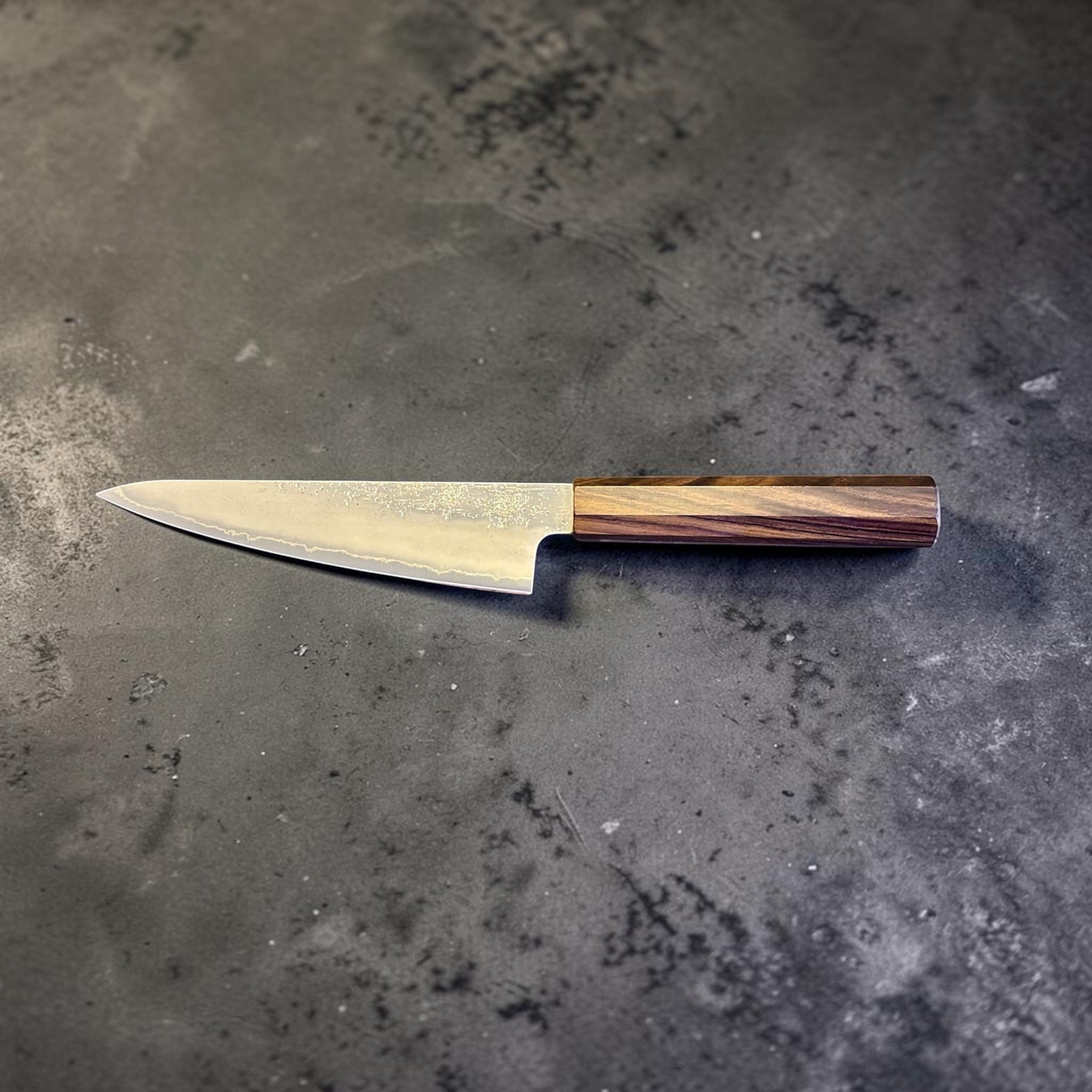 Hatsukokoro Ginrei Silver #3 Ko Santoku 150 mm with mono ebony handle, reverse side profile with textured blade finish.