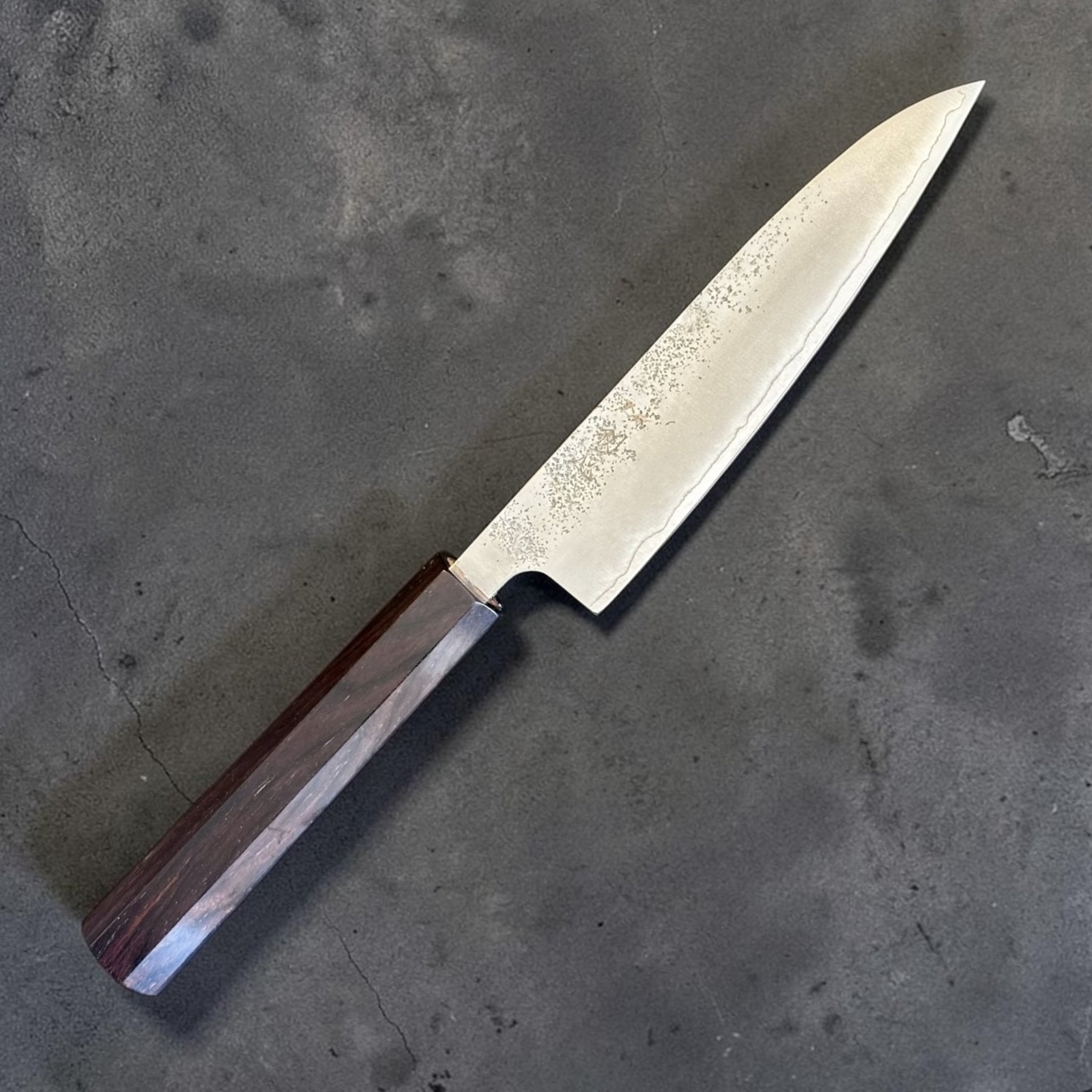 Hatsukokoro Ginrei Silver #3 Petty 130 mm with mono ebony handle, angled view showing pointed petty blade profile.