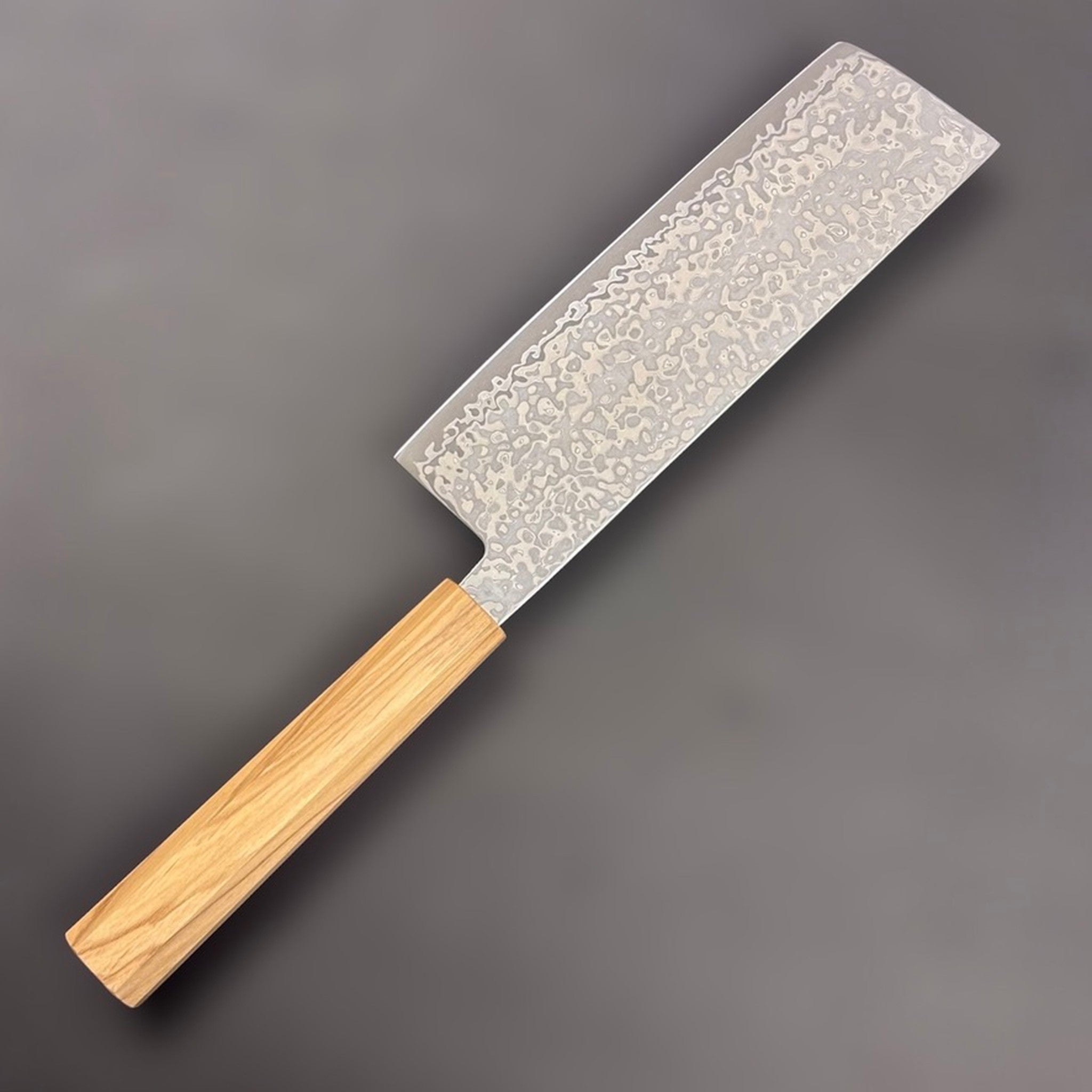 Hatsukokoro Hikari SLD Damascus Nakiri 160 mm with olive wood handle, reverse side view of blade finish.