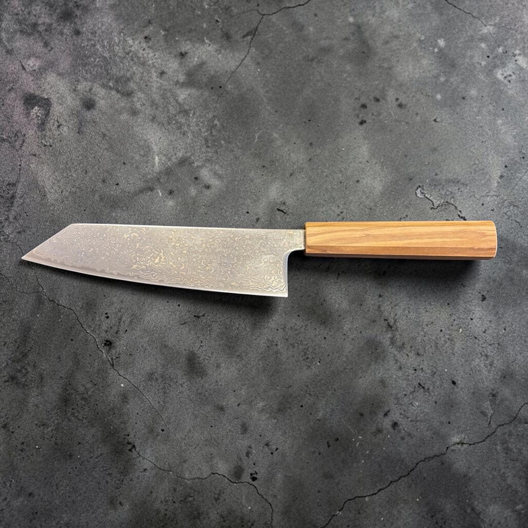 Hatsukokoro Hikari SLD Damascus Kurozome Bunka 170 mm with olive wood handle, full profile view with blade facing left.
