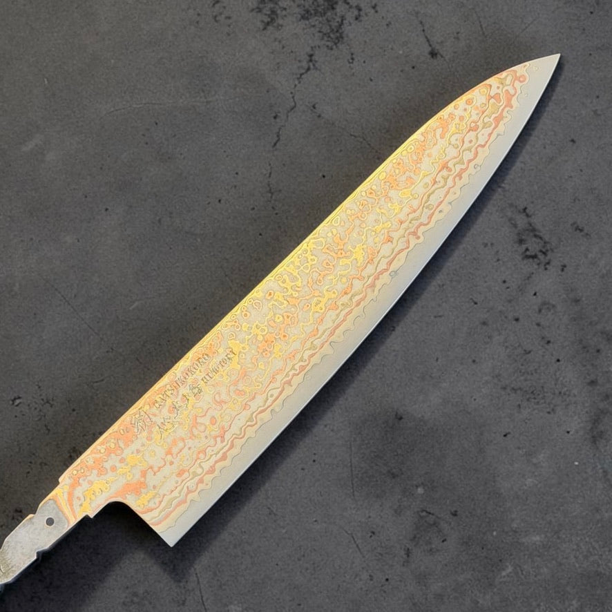 Hatsukokoro Hinotori V-Toku2 Rainbow Damascus Gyuto 210mm blade only, front side showing the chef knife profile and layered copper and brass Damascus.