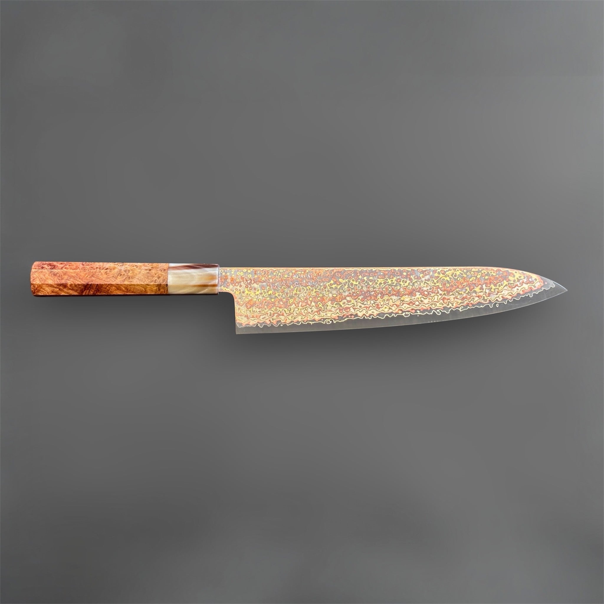 Hatsukokoro Hinotori V-Toku2 Rainbow Damascus Gyuto 240 mm with amboyna burl handle, full side profile on a gray background.