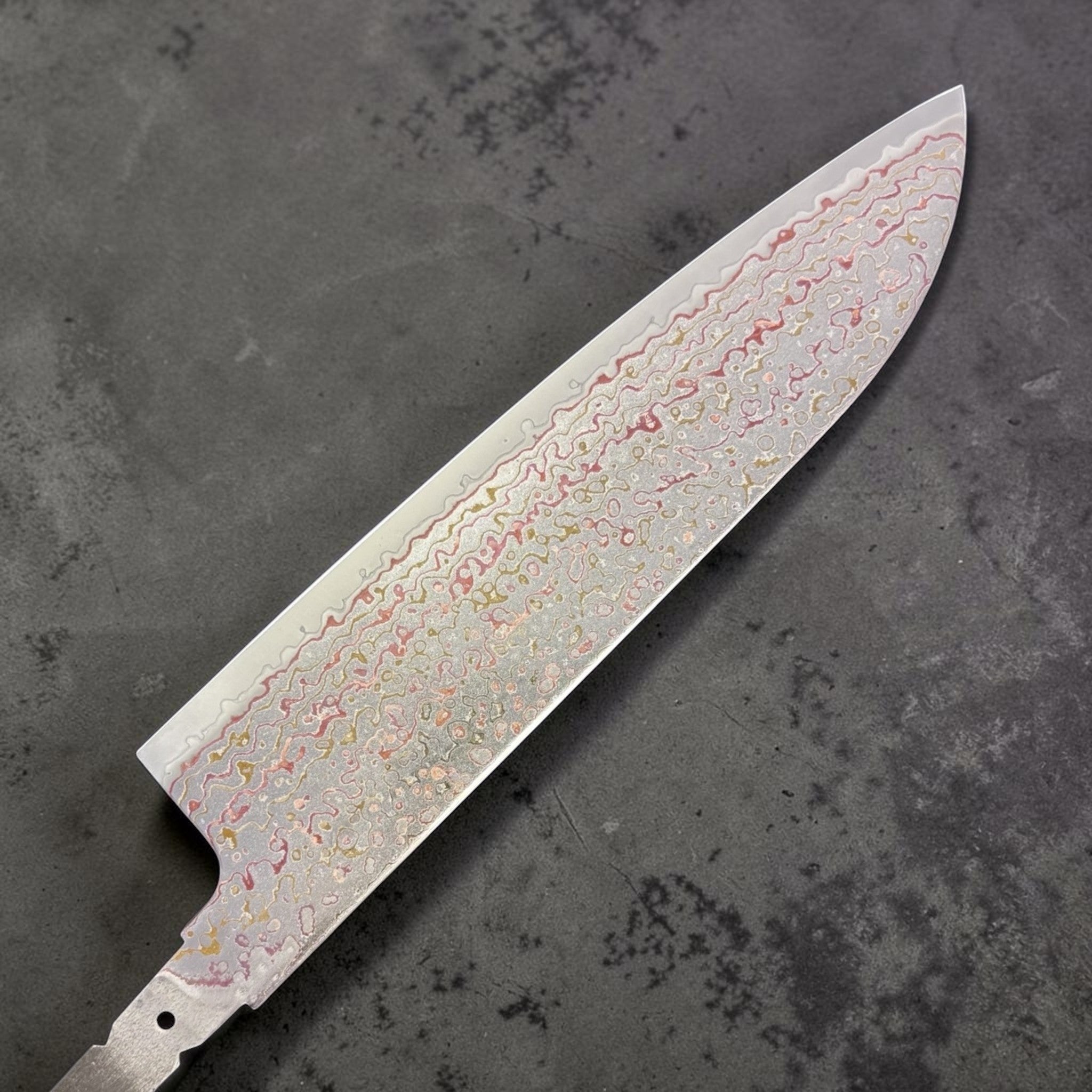 Kujaku rainbow damascus pattern close-up on santoku blade