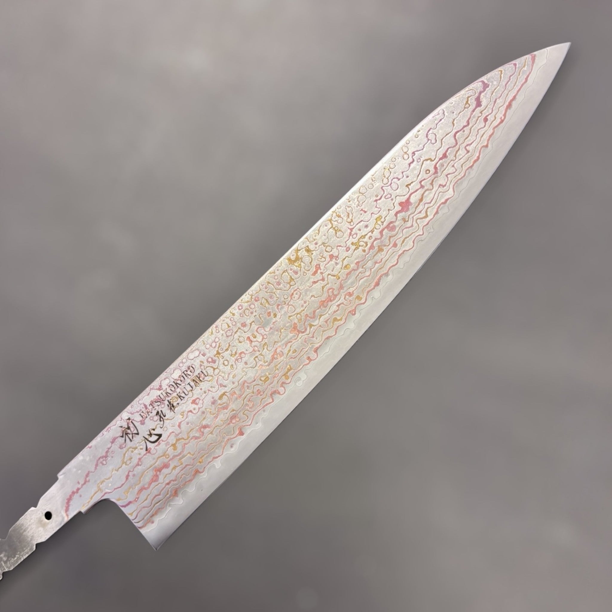 Hatsukokoro Kujaku V-Toku2 Rainbow Damascus Gyuto 210 mm close-up of the upper blade and tip, showing colorful damascus waves.
