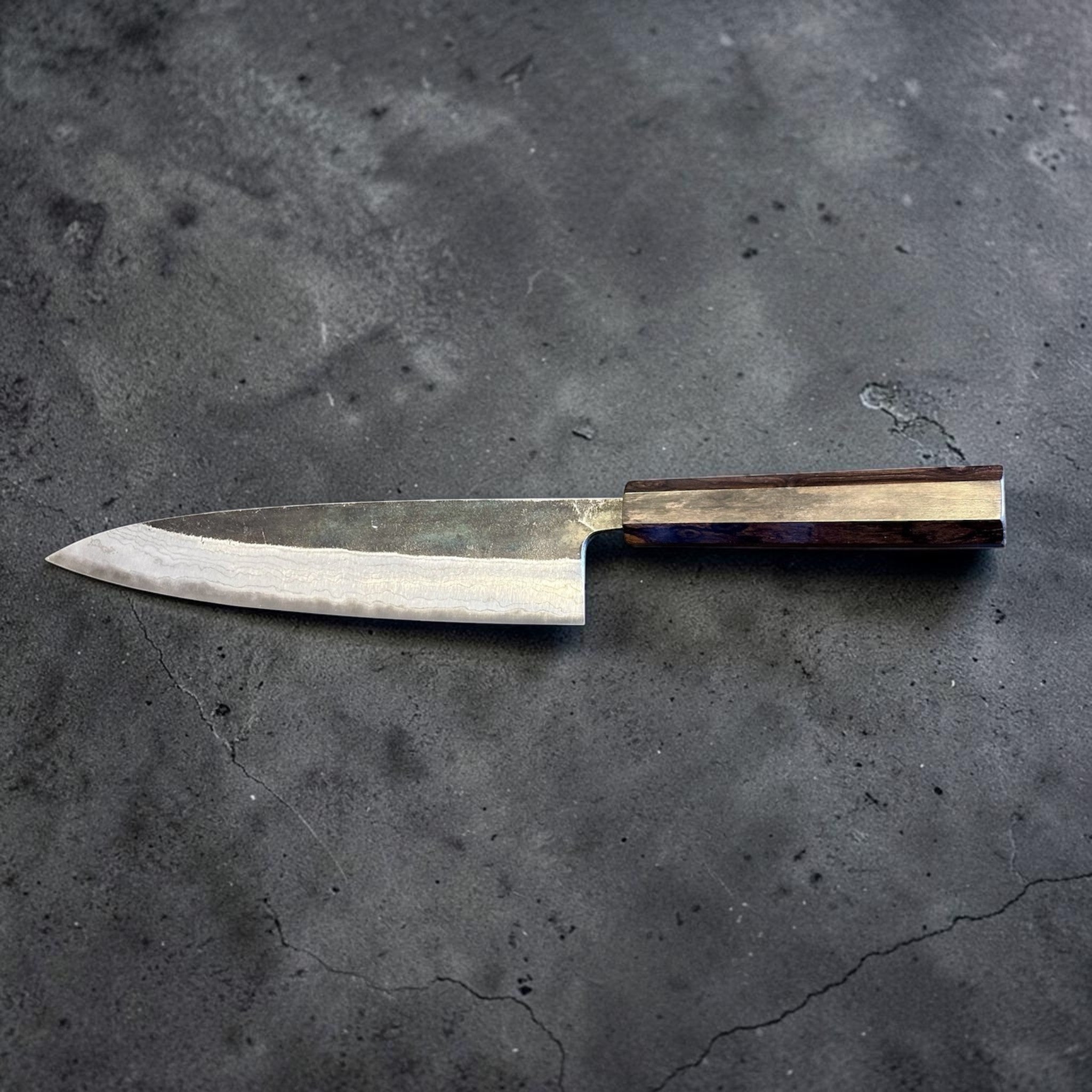 Hatsukokoro Kumokage Blue #2 Gyuto 240 mm with mono ebony handle, side profile showing the blade geometry and wa handle.