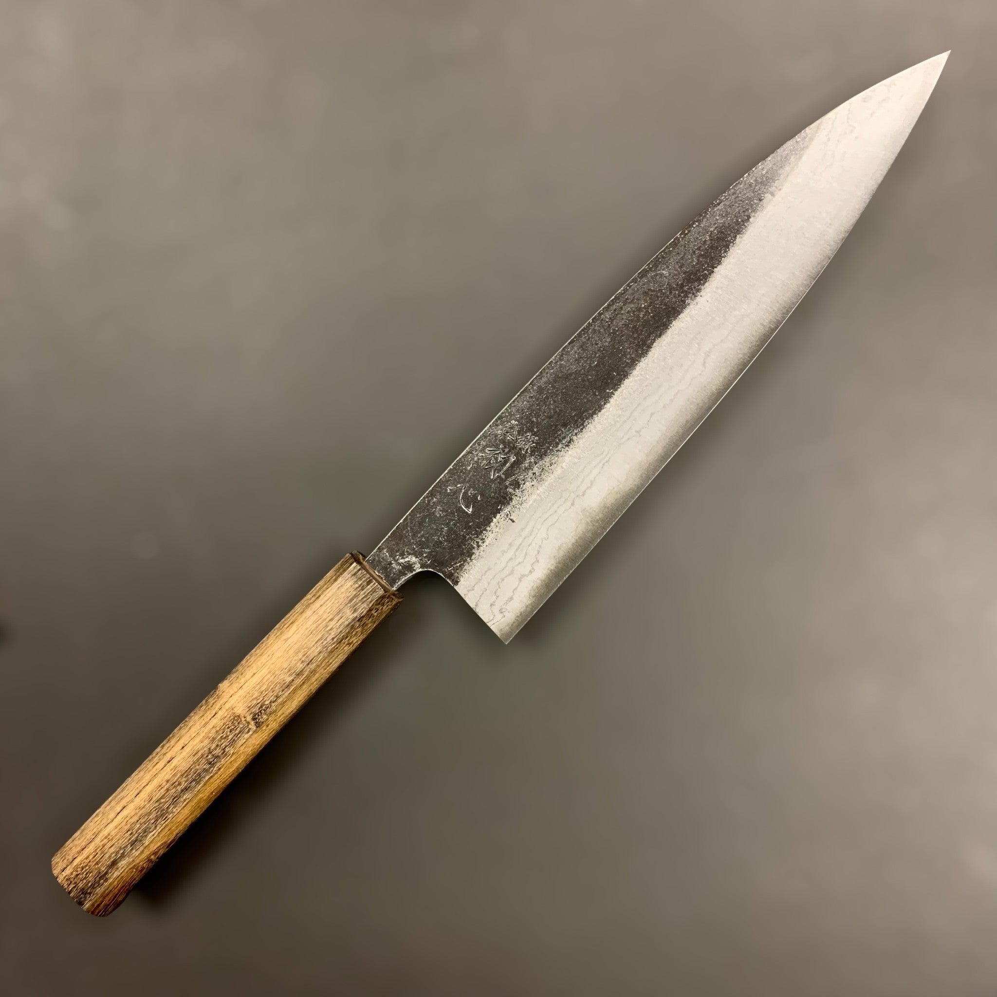 Hatsukokoro Kumokage Blue #2 Kurouchi Damascus Gyuto 210 mm, showing layered Damascus finish and rustic kurouchi cladding.