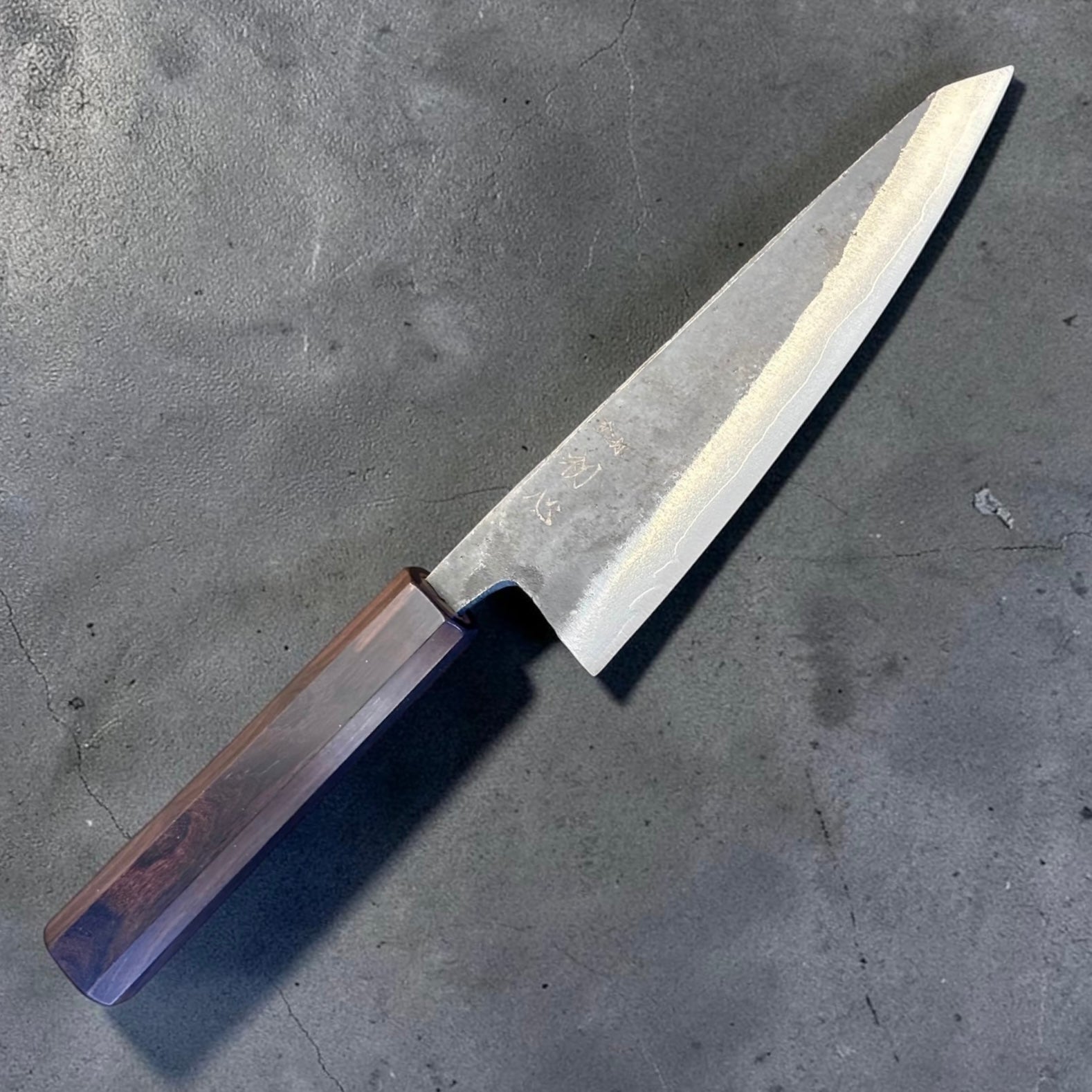 Hatsukokoro Kurogane Blue #2 Kurouchi Honesuki 150mm with mono ebony handle, angled kanji-side view