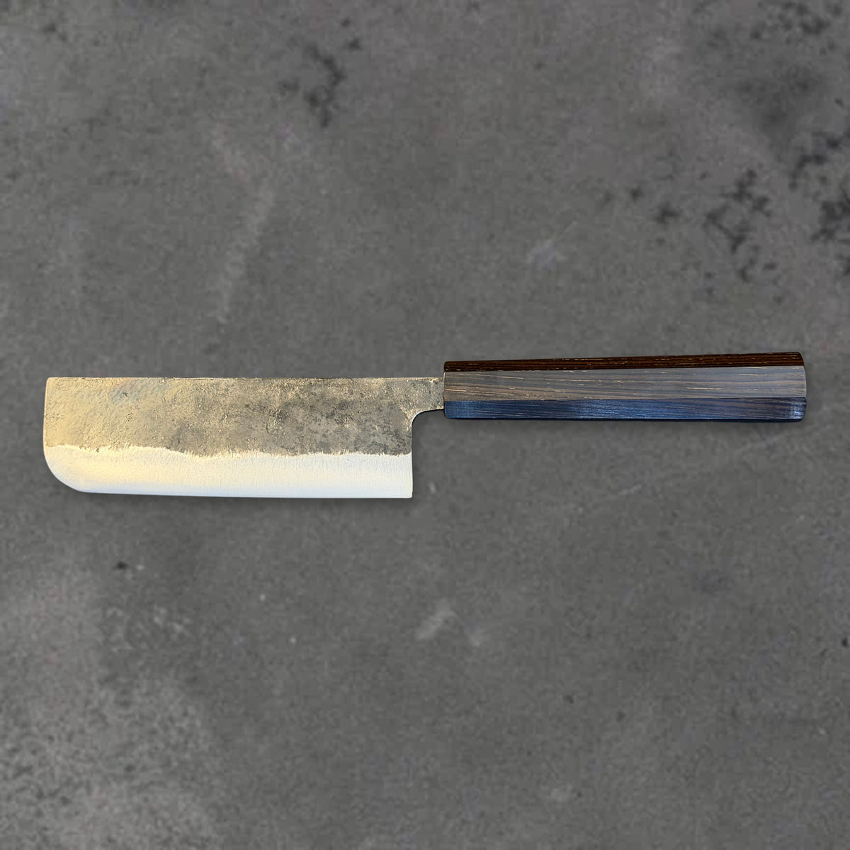 Hatsukokoro Kurogane Blue #2 Kurouchi 120mm nakiri with ebony handle, shown in horizontal reverse profile with the full blade and handle visible. #Handle_Mono Ebony