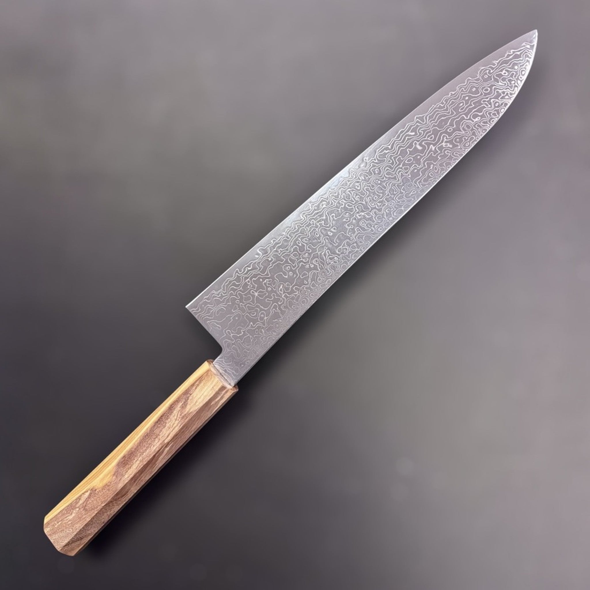Hatsukokoro Ryuhyo SG2 Damascus Gyuto 240 mm, choil view showing the thin spine taper above the octagonal olivewood handle.