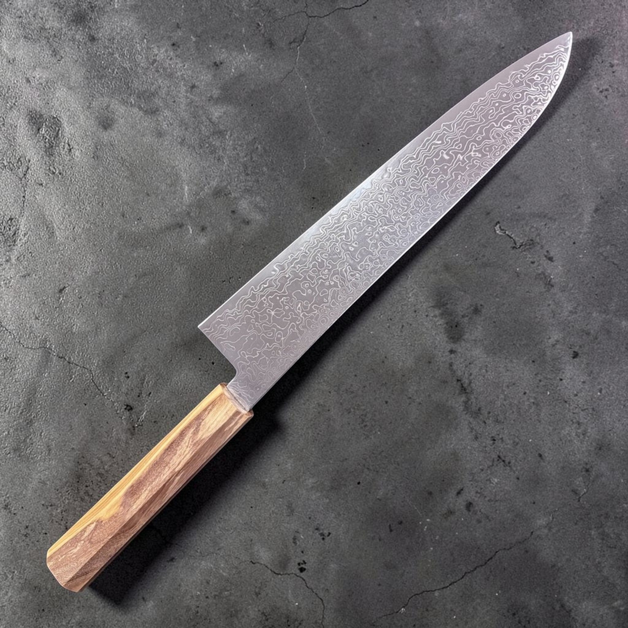 Hatsukokoro Ryuhyo SG2 Damascus Gyuto 240 mm, choil view showing the thin spine taper above the octagonal olivewood handle.