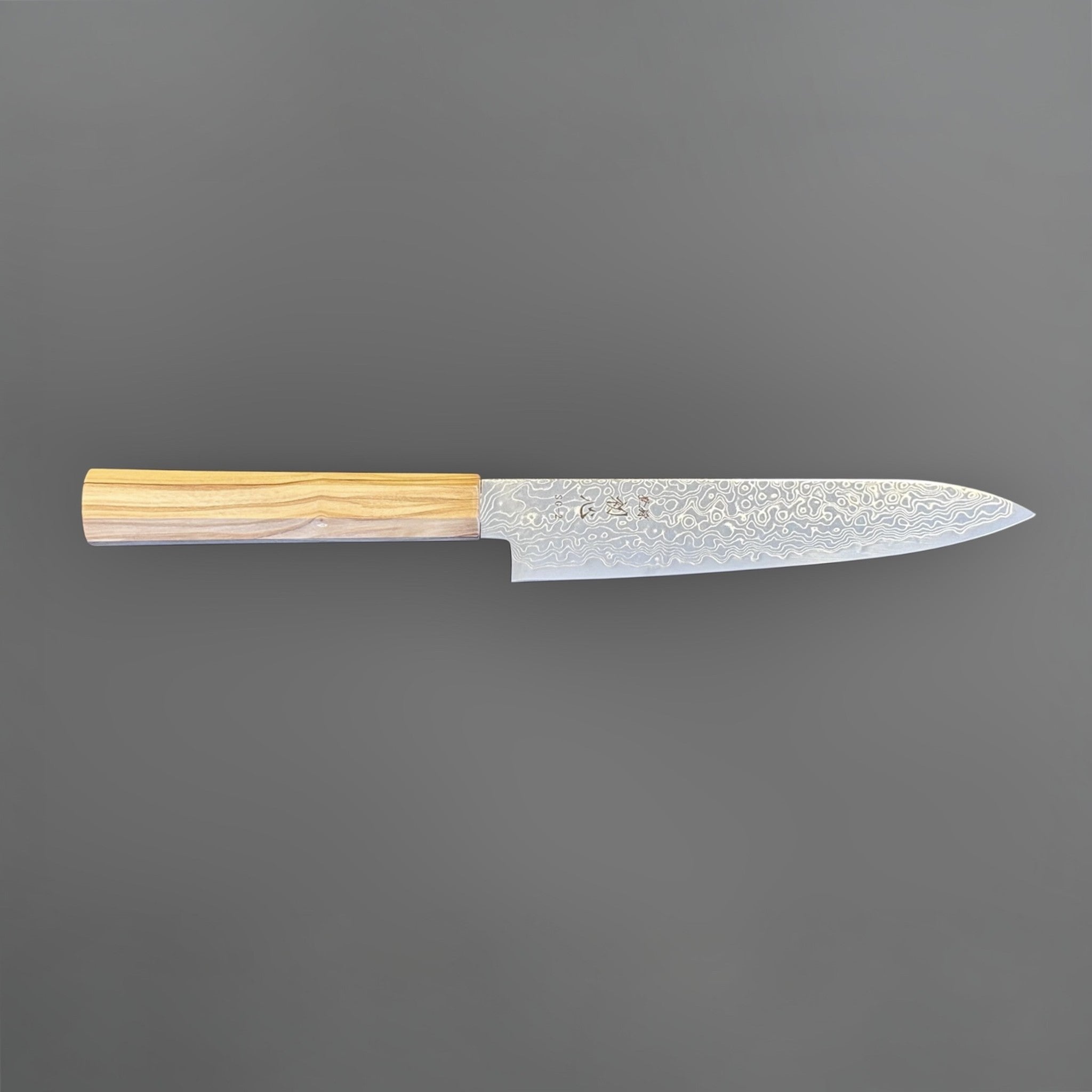 Hatsukokoro Ryuhyo SG2 Damascus Petty 150 mm with olive wood handle, full side profile showing the flowing Damascus blade pattern.