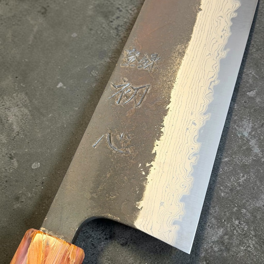 Close-up of Hatsukokoro Shinkiro Aogami Super kurouchi Damascus blade and hand-engraved kanji