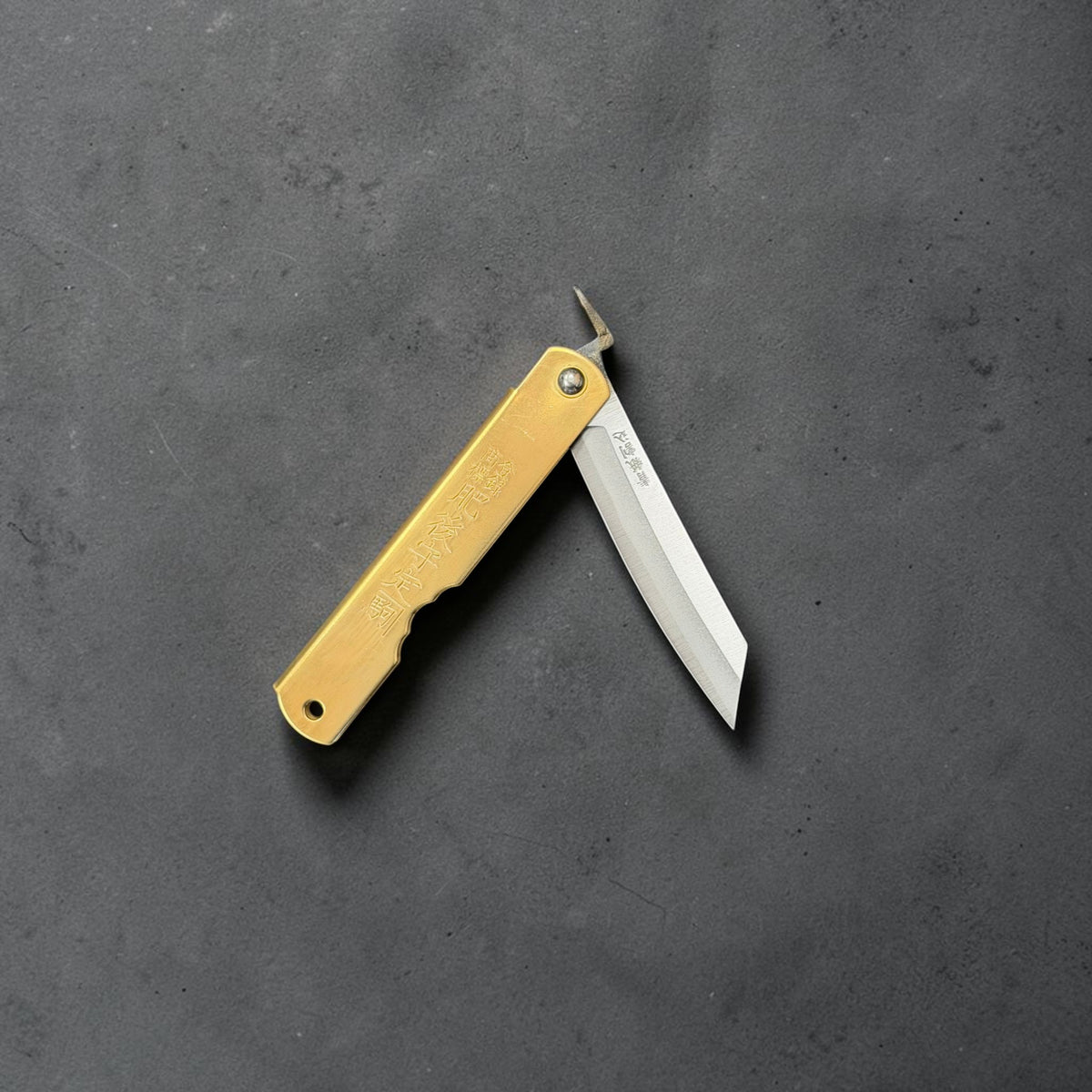 Higonokami Blue #2 medium friction folder partly open, showing the blade pivot and extended tang.