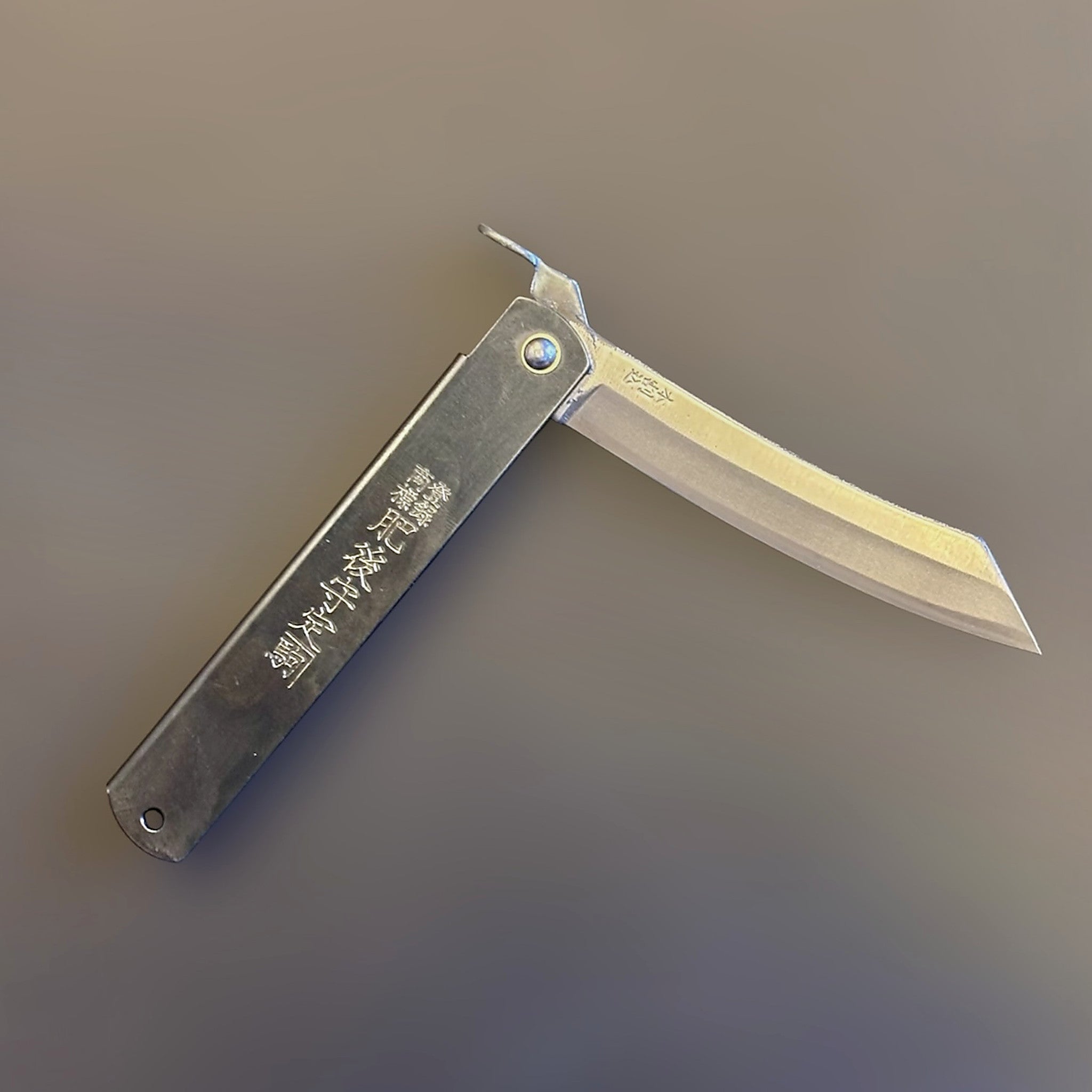 Higonokami Carbon Steel Japanese Friction Folder, three-quarter product view with blade partially open.
