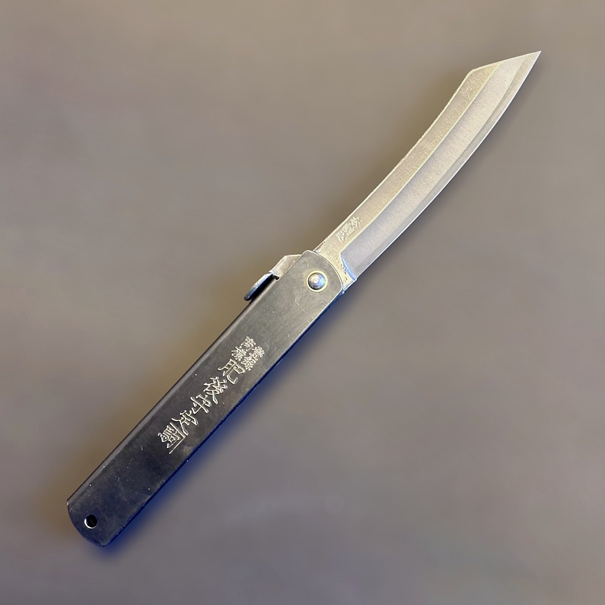 Higonokami Carbon Steel Japanese Friction Folder, three-quarter product view with blade open.