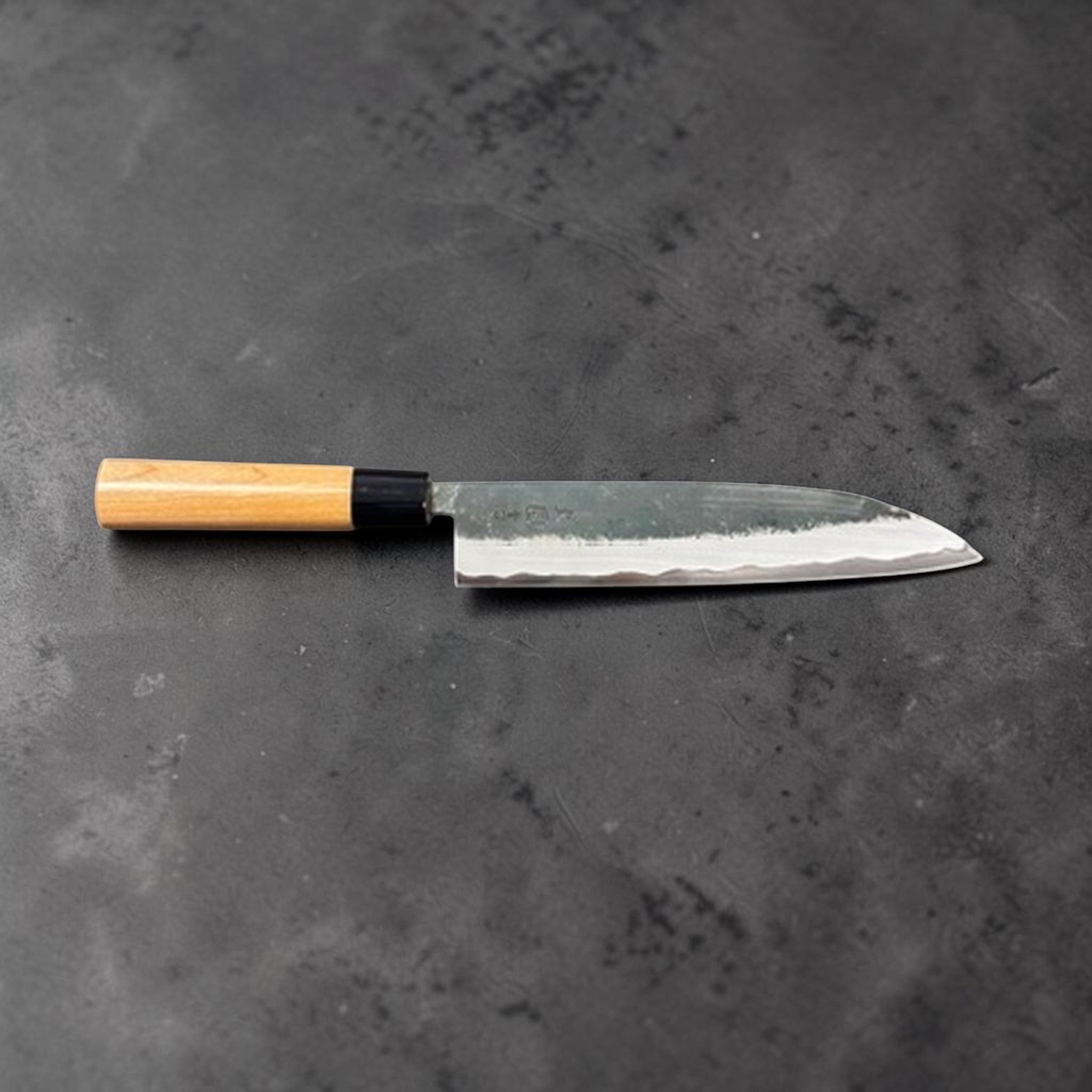 Hinokuni Aogami Super Kurouchi Gyuto 210 mm, profile side view of the blade on a neutral background.