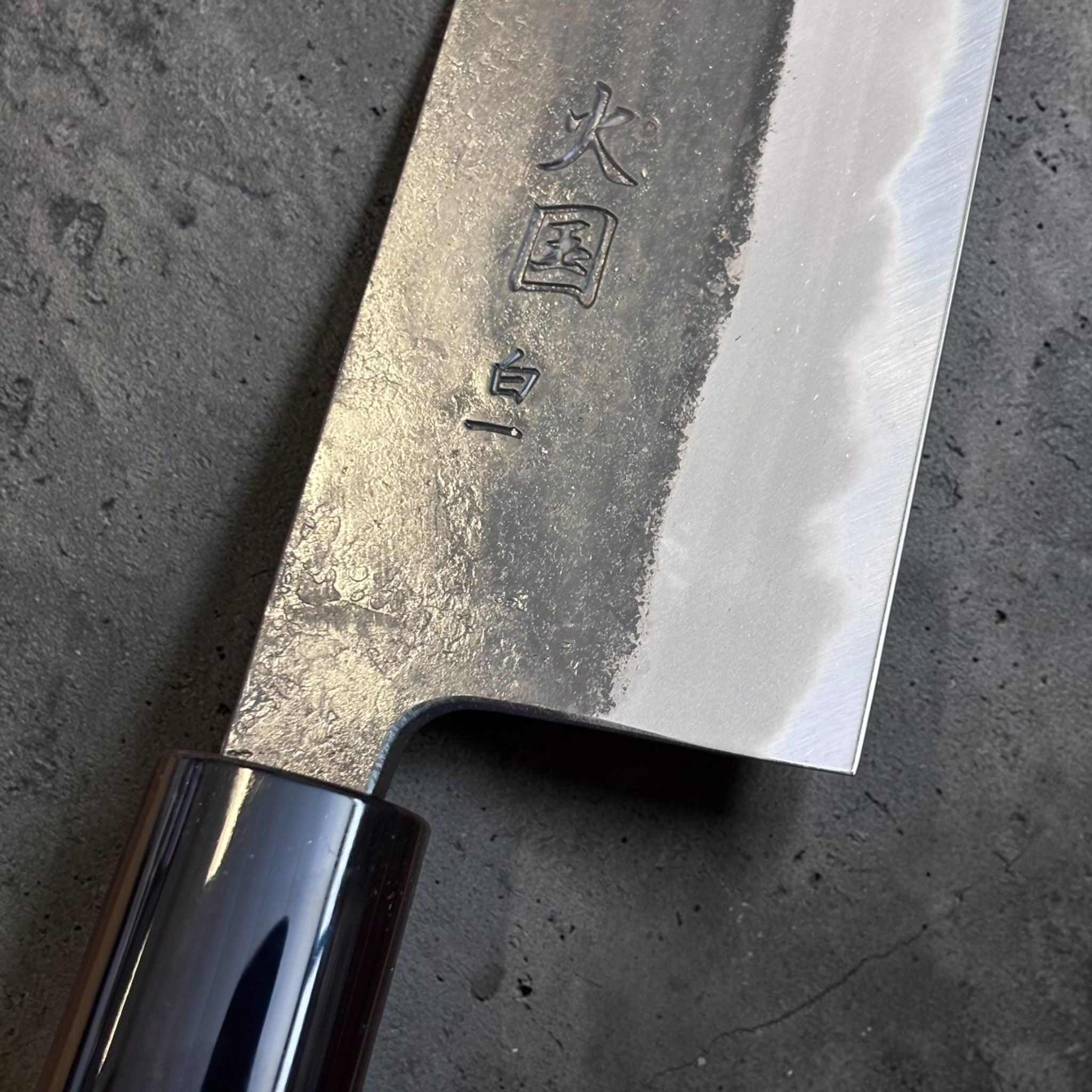 Hinokuni White #1 Kurouchi Bunka, close-up of maker kanji, kurouchi texture, and polished edge bevel.