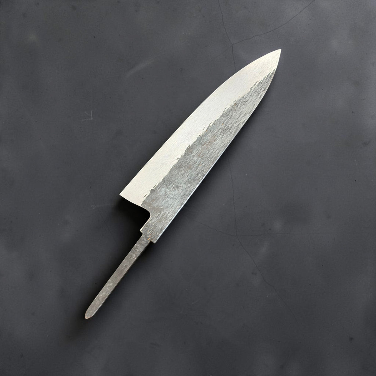 Reverse side of Isamitsu Aogami Super Gyuto 210mm blade with hammered finish and polished bevel
