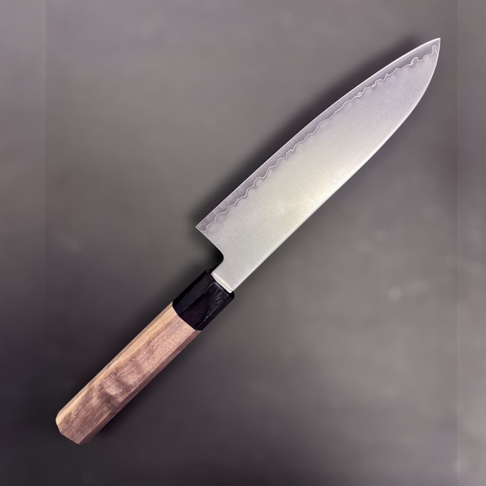 Kagekiyo Chromax Santoku 170 mm, left side profile highlighting the satin blade finish and wavy cladding line.