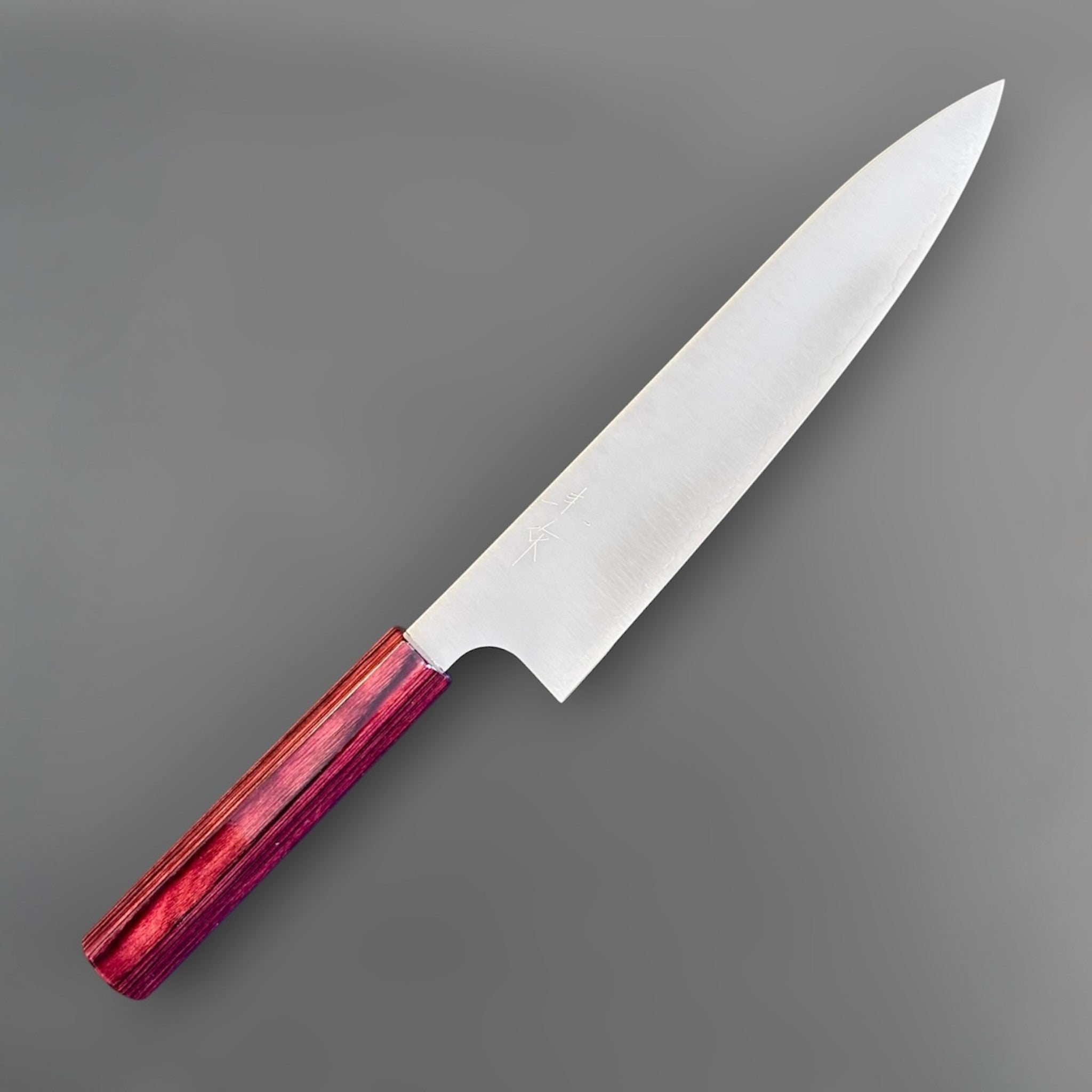 Kei Kobayashi SG2 Gyuto 210 mm with red lacquer handle, angled front-side view showing the polished blade, engraved kanji, and slim wa handle.