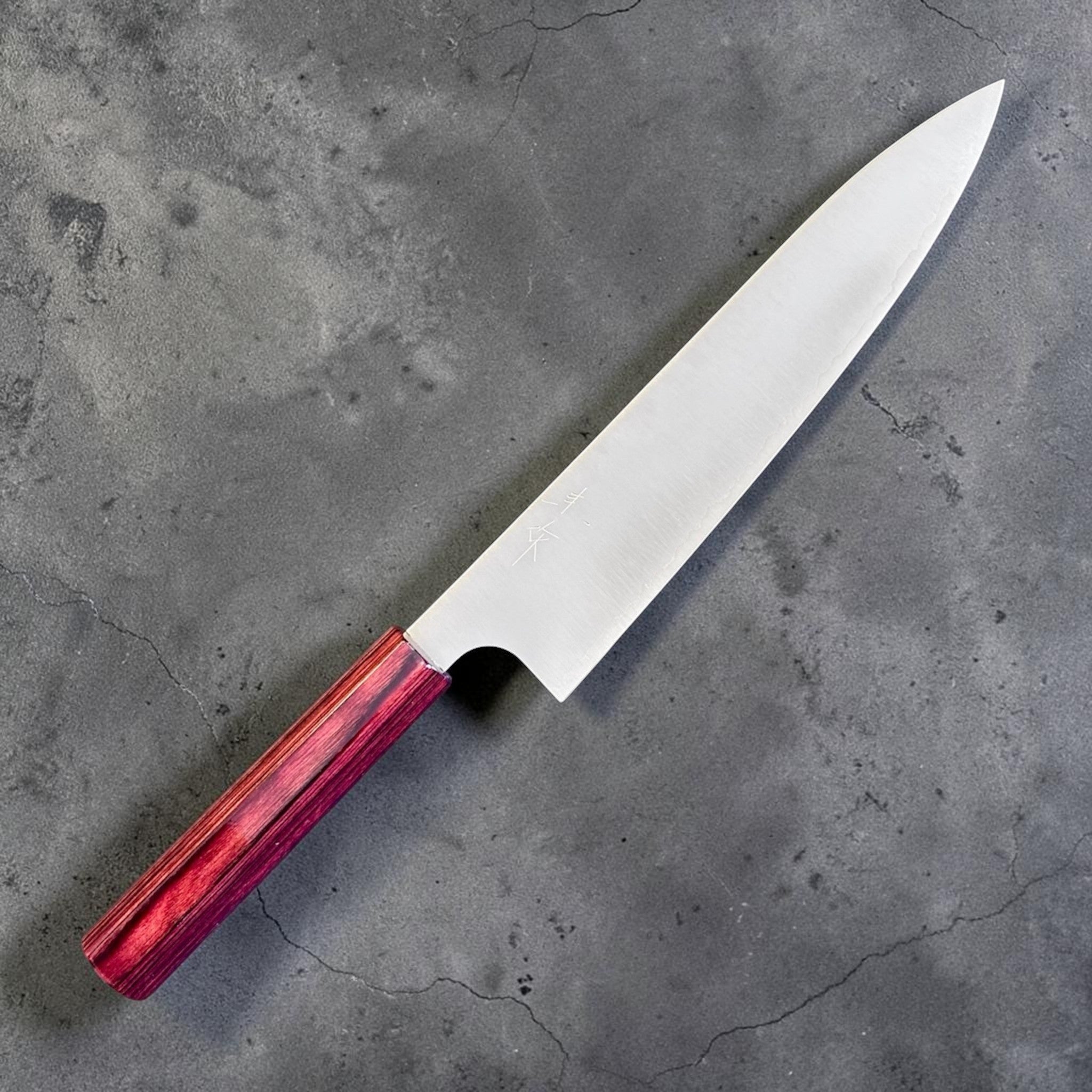 Kei Kobayashi SG2 Gyuto 210 mm with red lacquer handle, angled front-side view showing the polished blade, engraved kanji, and slim wa handle.