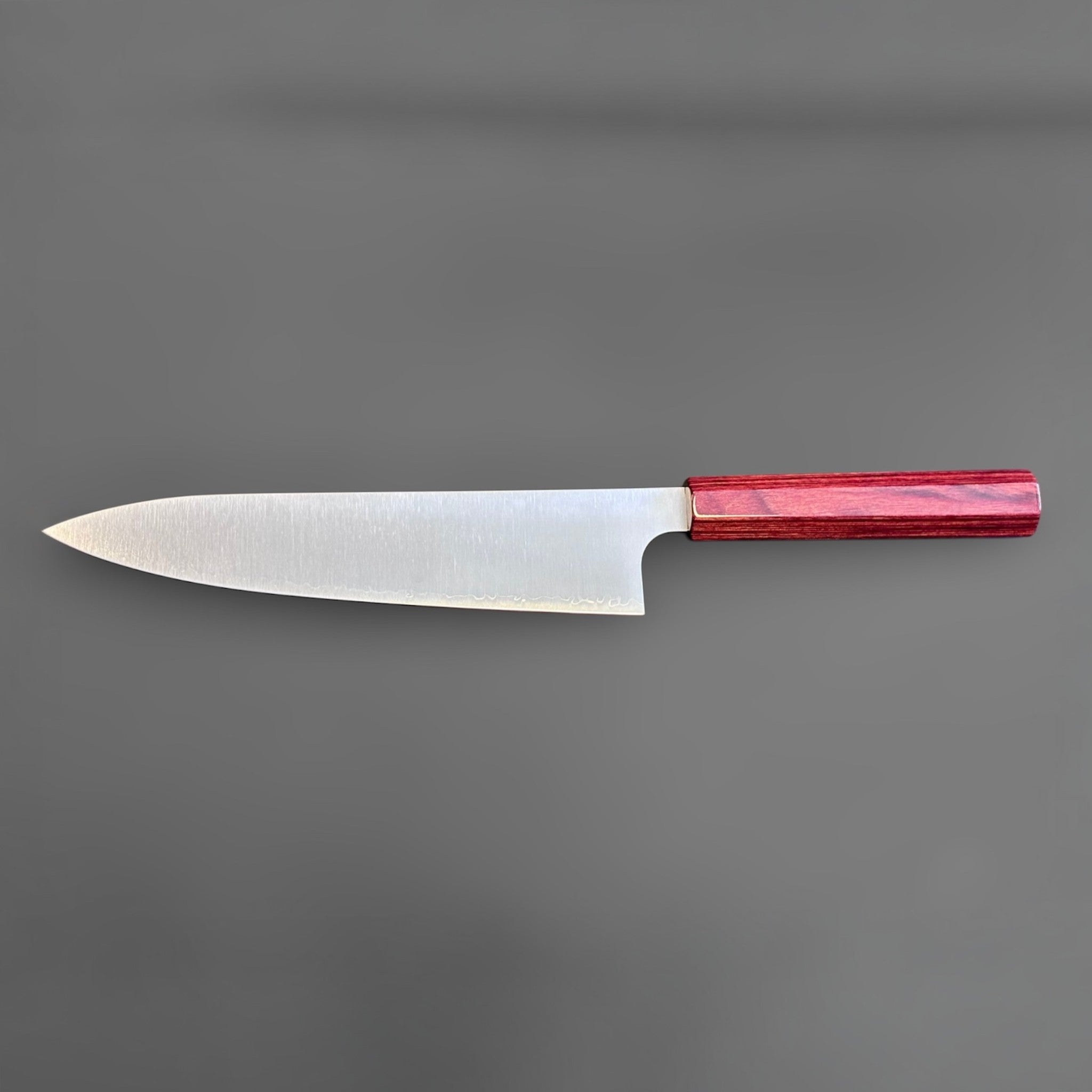 Kei Kobayashi SG2 Gyuto 210 mm with red lacquer handle, full reverse-side profile showing the sleek blade shape and polished finish.