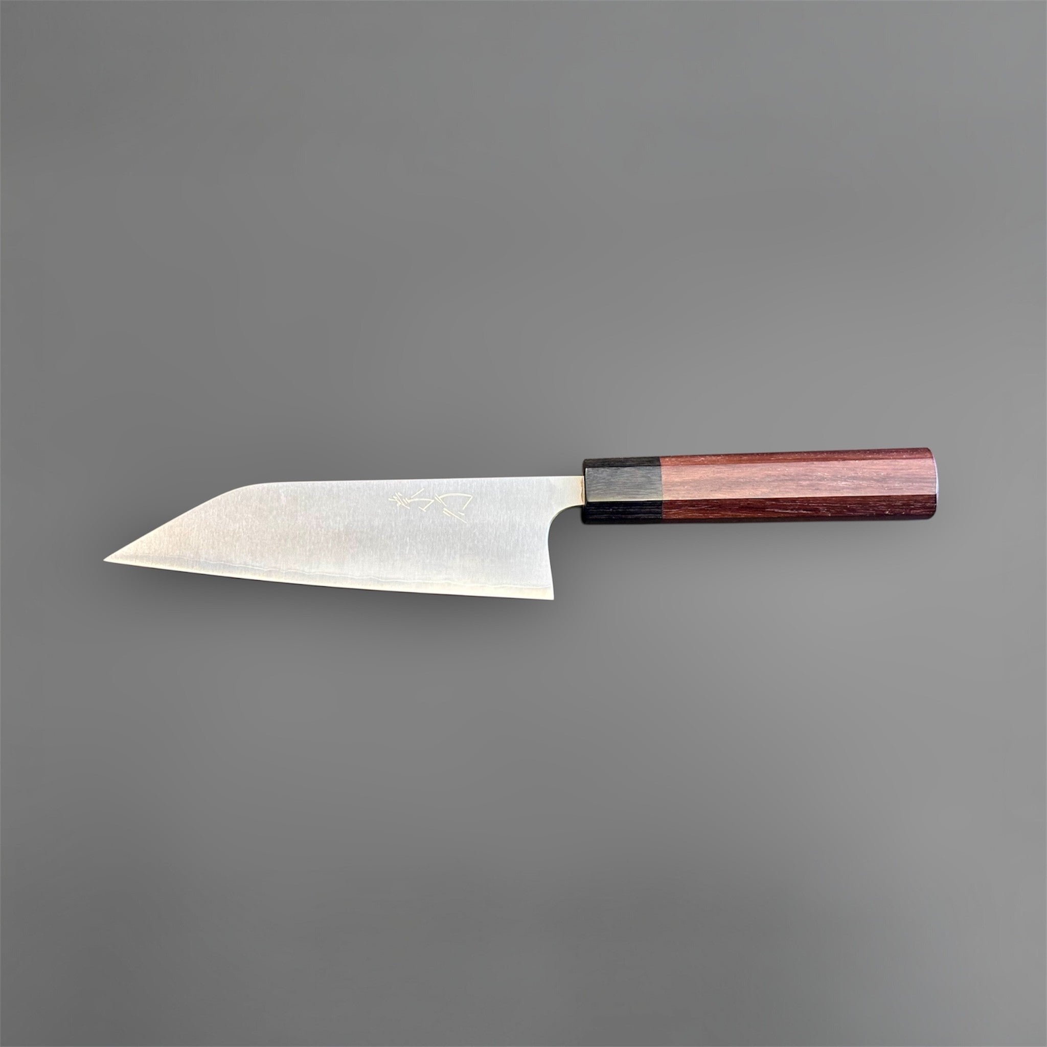Koutetsu Chromax Santoku with rosewood octagon handle, full reverse-side profile emphasizing the straight edge line, angled tip, and minimalist blade finish.