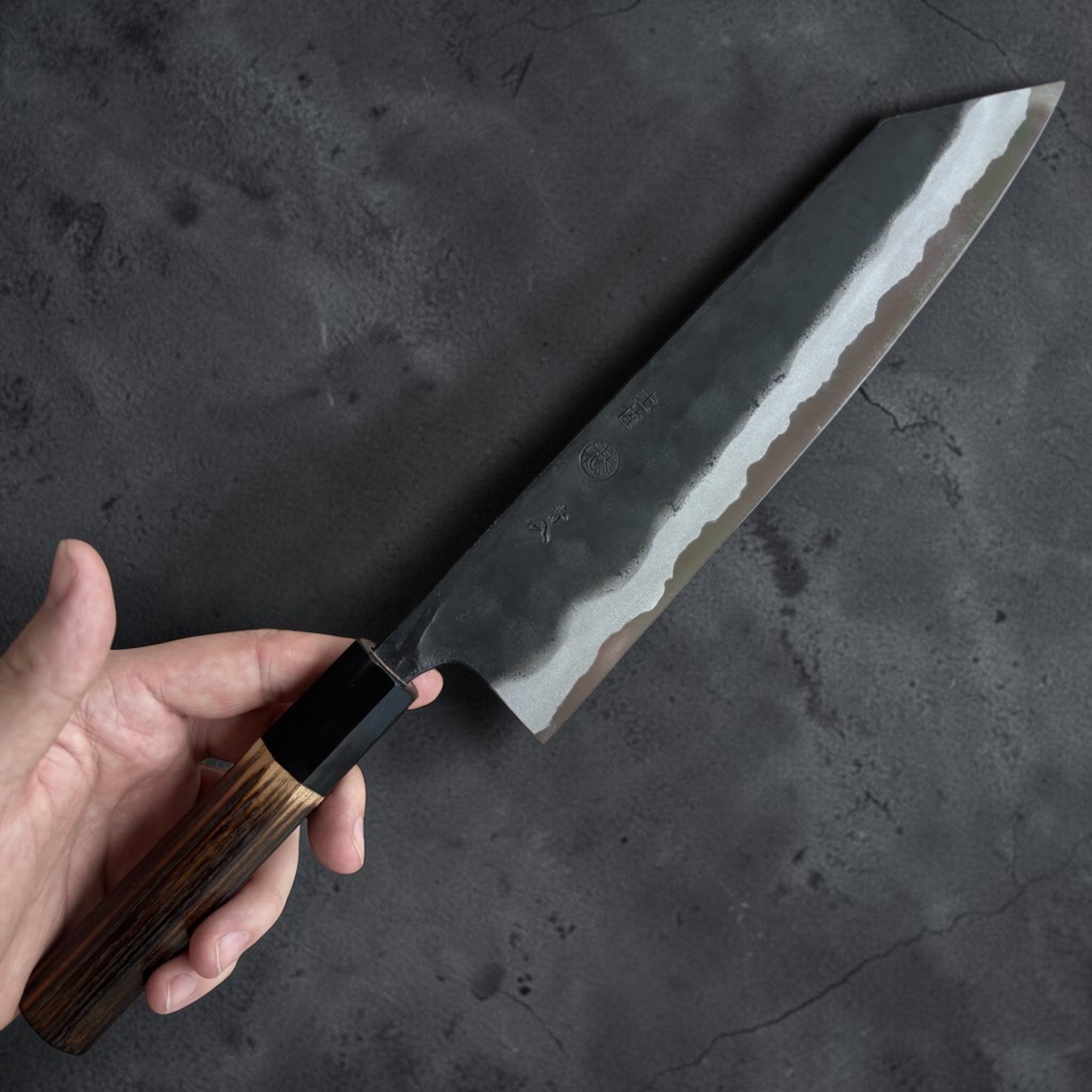 Kyohei Shindo Blue #2 Kurouchi Kiritsuke 210 mm with burnt wood handle and buffalo horn ferrule, reverse side blade profile and kurouchi finish.