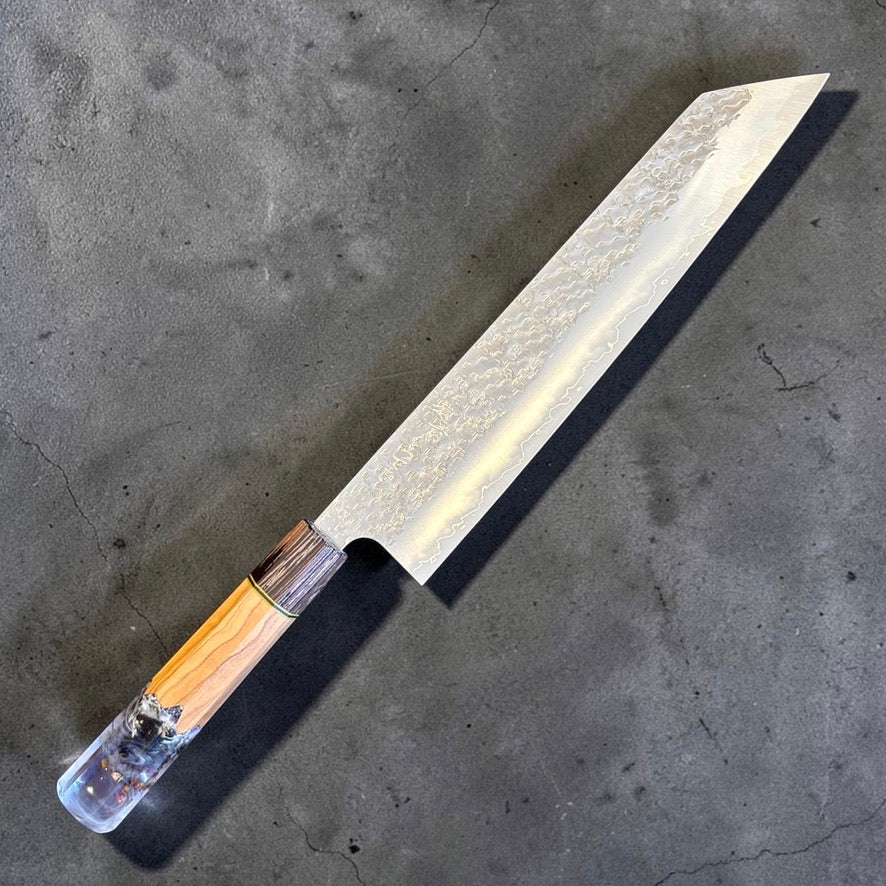 Makoto Kurosaki SG2 Bunka 240mm blade profile showing decorative hammered pattern, kasumi finish and bright cladding line