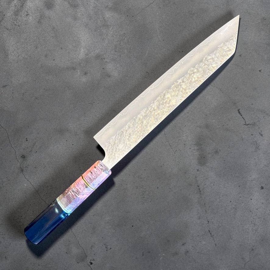 Three Makoto Kurosaki SG2 Bunka 240mm knives with custom Prisma handles, hammered pattern, kasumi finish and highlighted cladding line