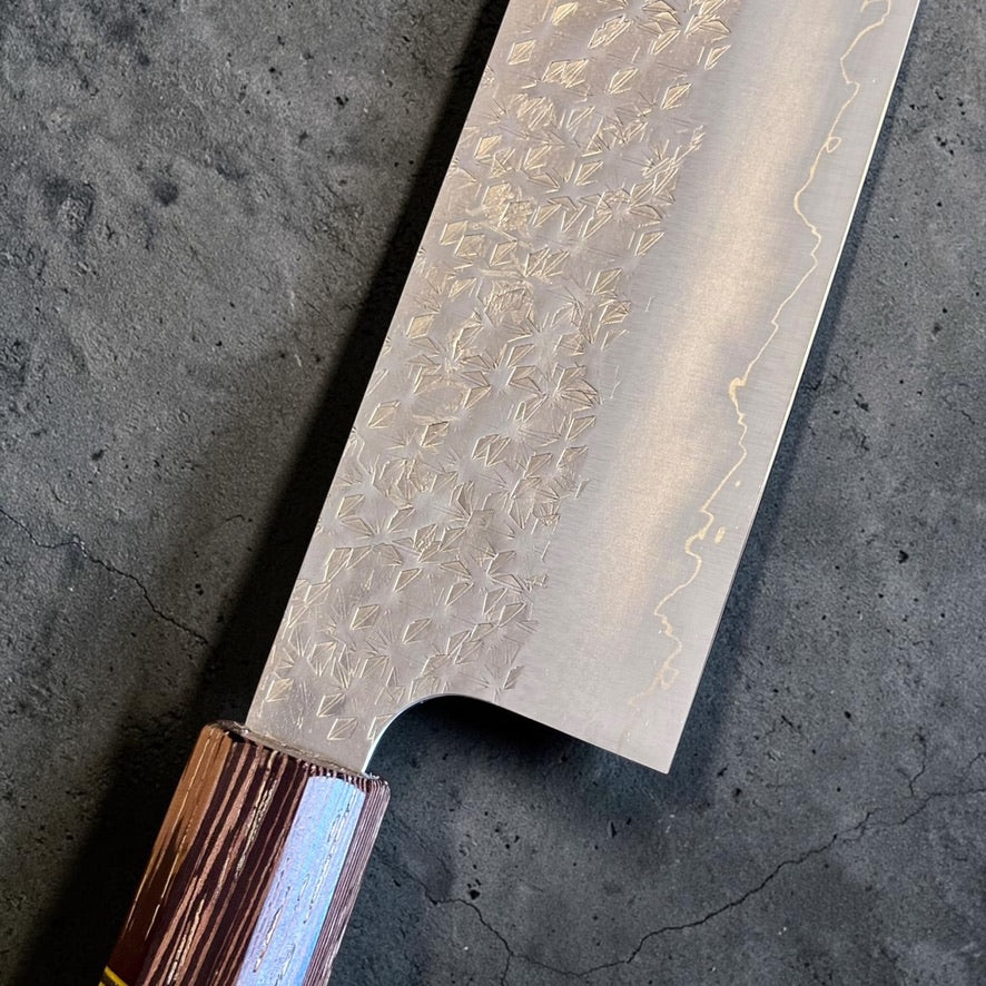 Spine view of Makoto Kurosaki SG2 Bunka 240mm showing distal taper toward the long K-tip and Prisma wa handle