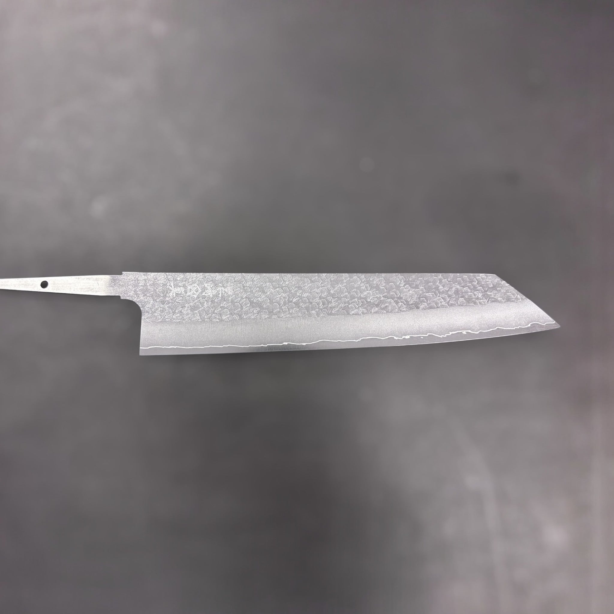 Makoto Kurosaki VG-XEOS Tsuchime Bunka 240 mm, full blade shot without handle against a neutral grey background.