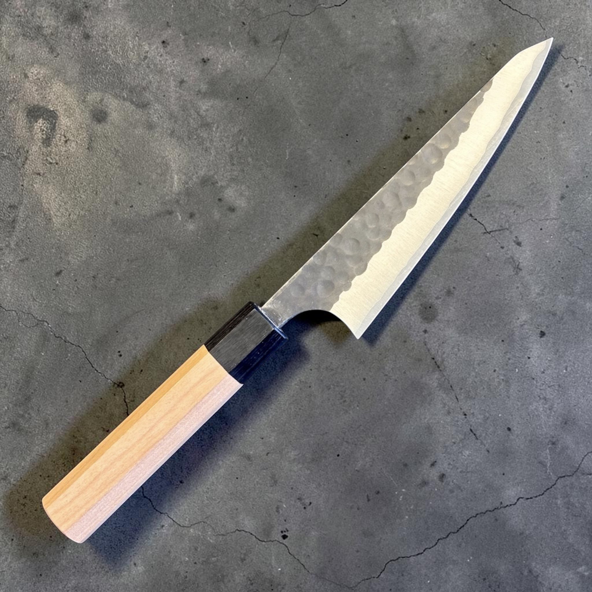 Masakage Koishi Honesuki Japanese knife, angled reverse-side product view with pointed triangular profile and octagonal wa handle.