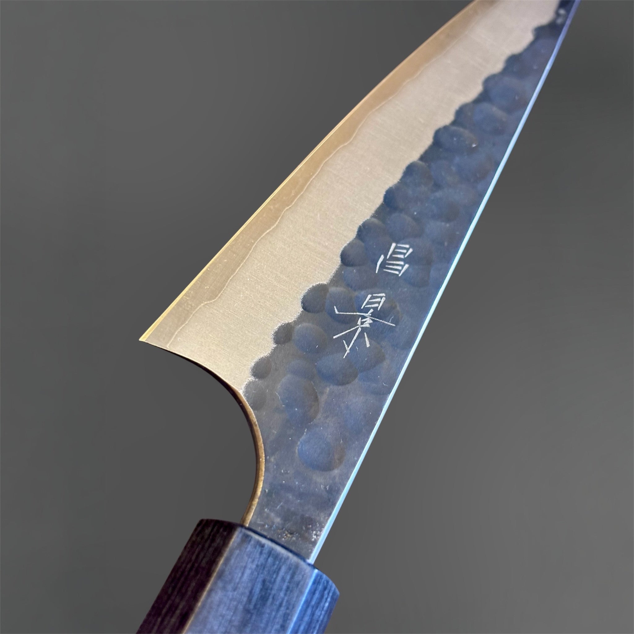 Masakage Koishi Honesuki Japanese knife, close-up of the heel and kanji engraving with hammered finish detail.