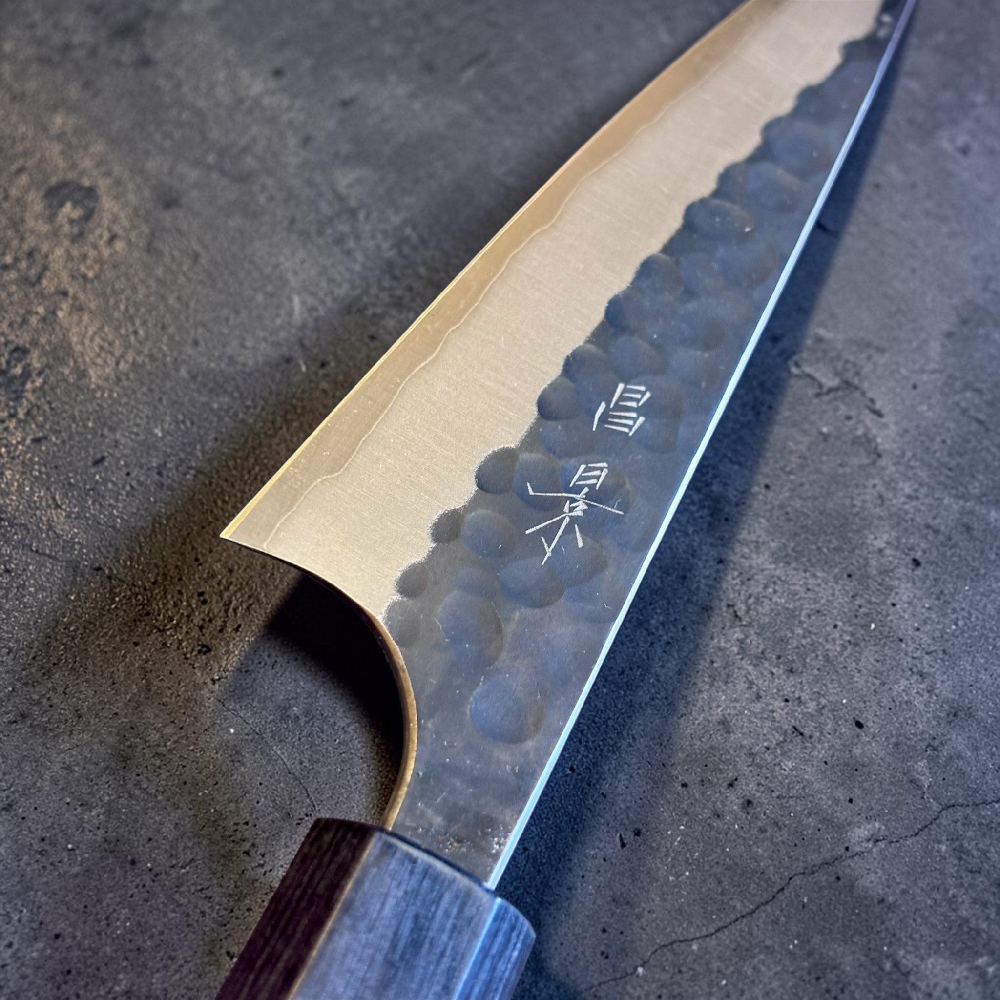 Masakage Koishi Honesuki Japanese knife, close-up of the heel and kanji engraving with hammered finish detail.