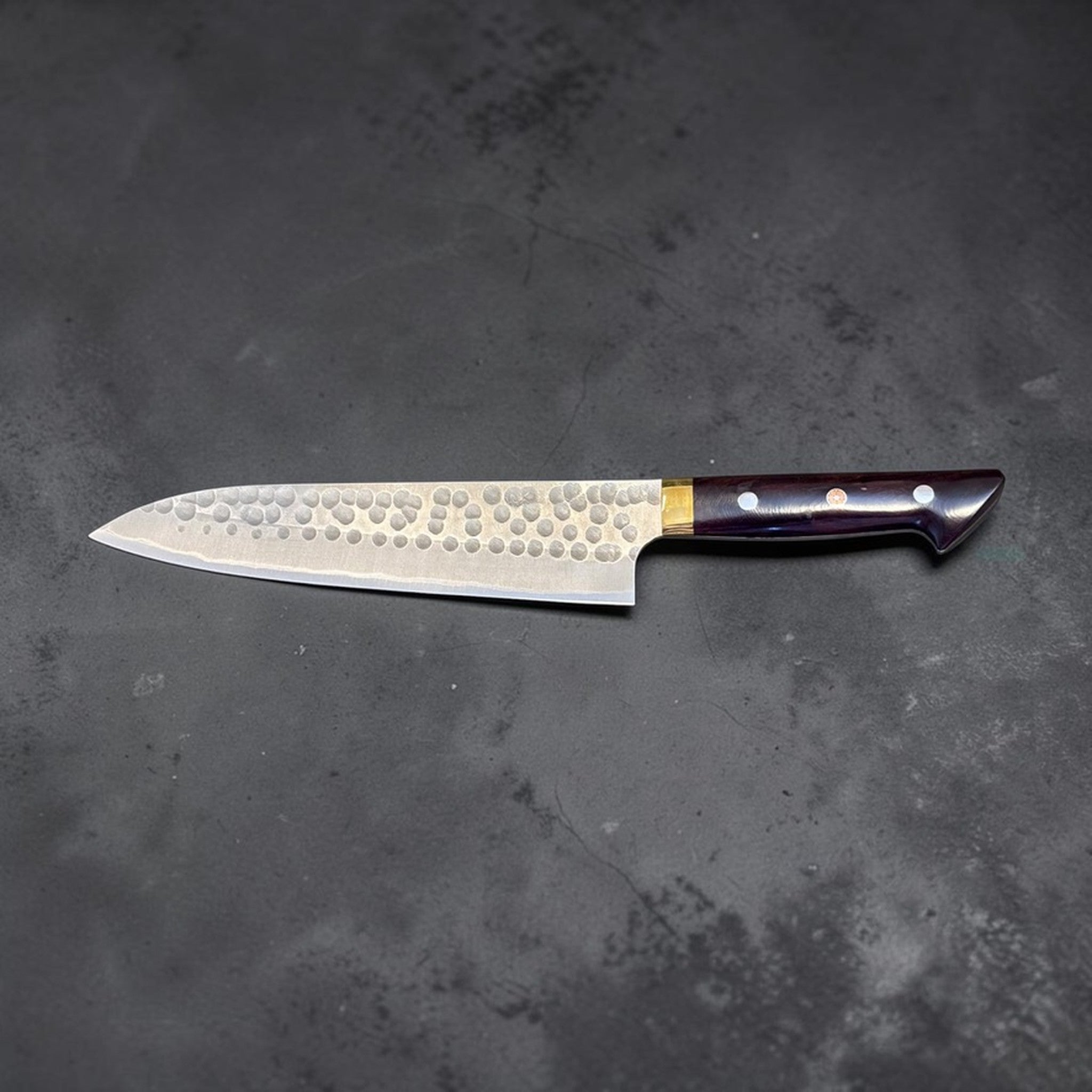 Masakage Zero Gyuto 210 mm, full knife left-facing profile showing hammered blade finish and western handle.
