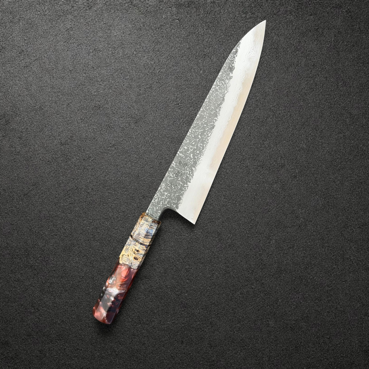 Masuda Blue 1 Kurozome Damascus Gyuto 210mm with red-and-gold Prisma handle, angled engraved-side view